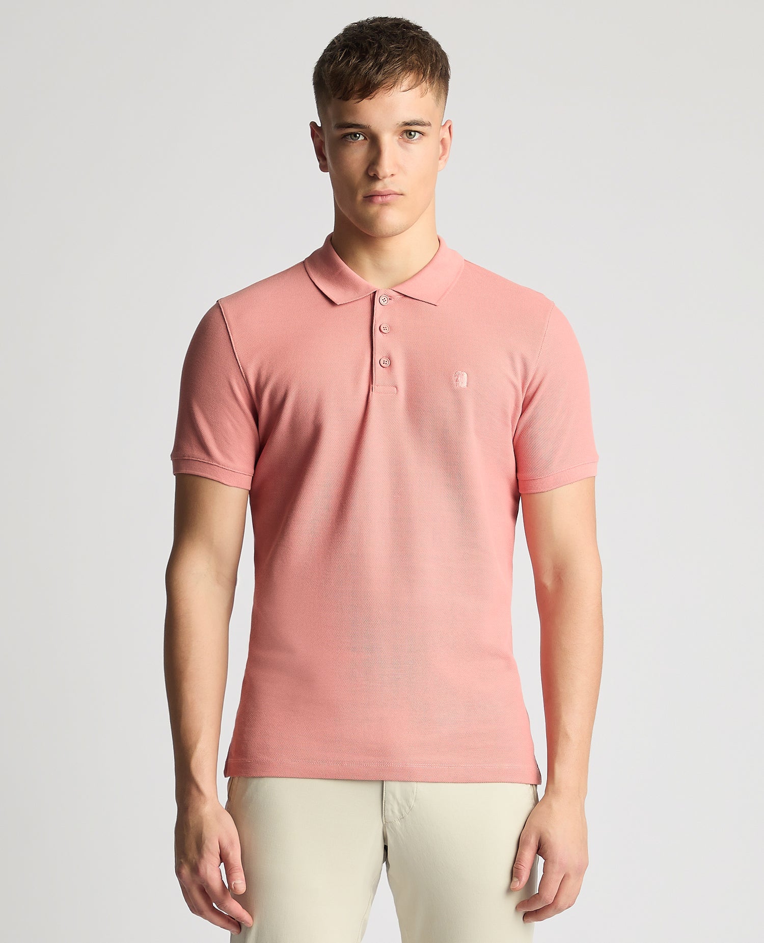 Man wearing a red Tapered Fit Cotton Pique Polo Shirt