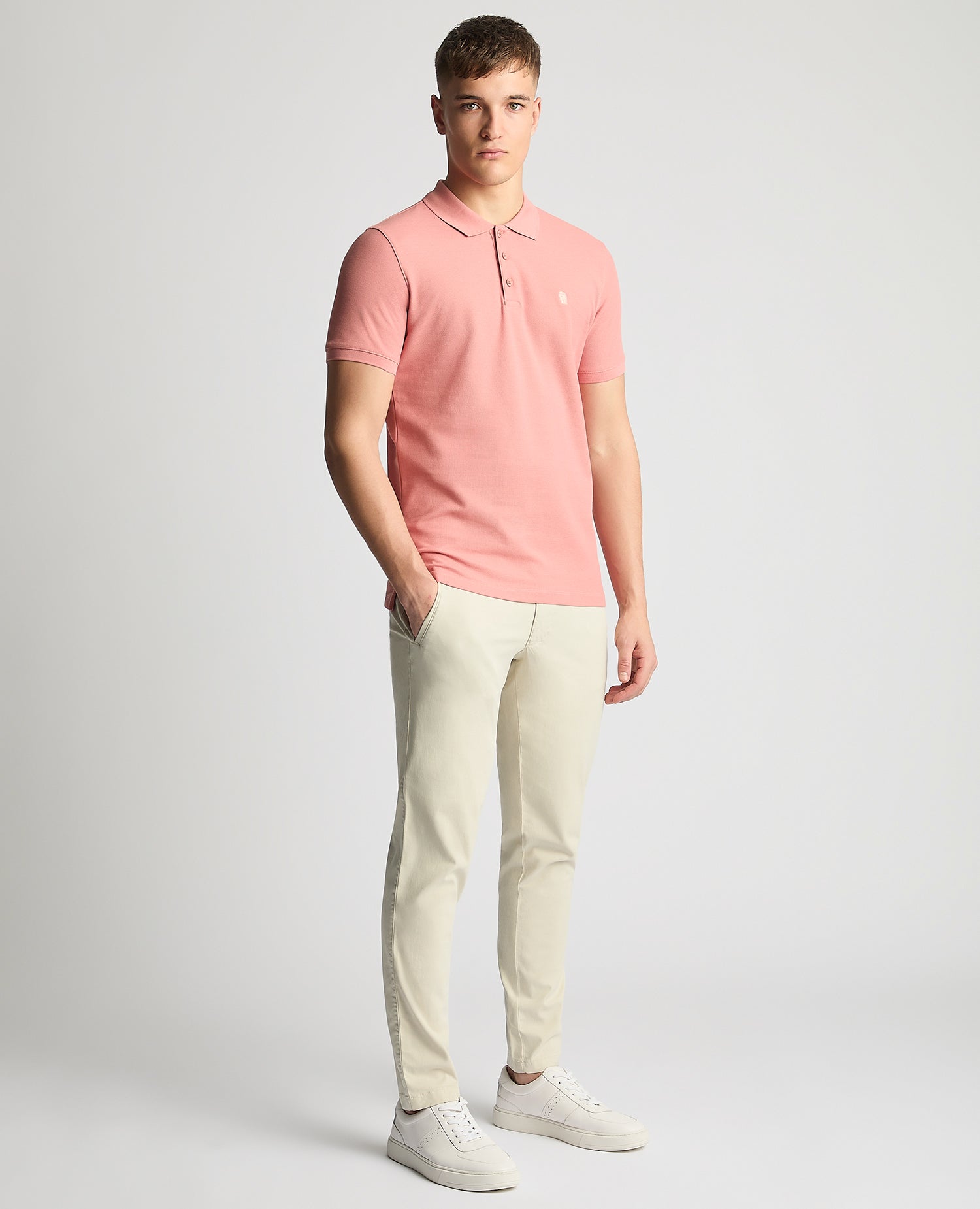 Man wearing a red Tapered Fit Cotton Pique Polo Shirt