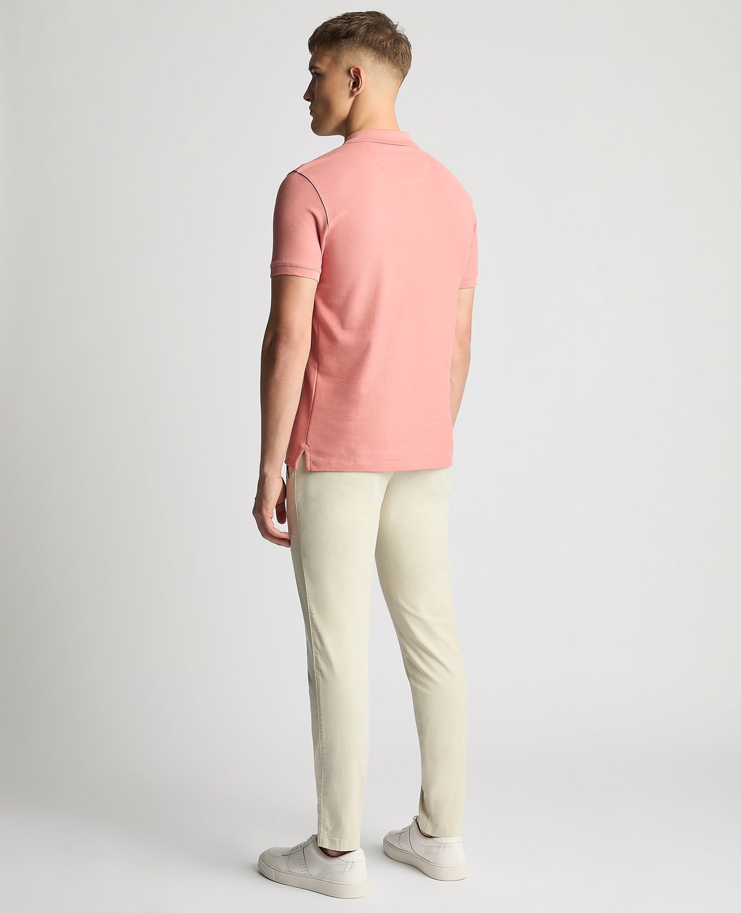 Man wearing a red Tapered Fit Cotton Pique Polo Shirt