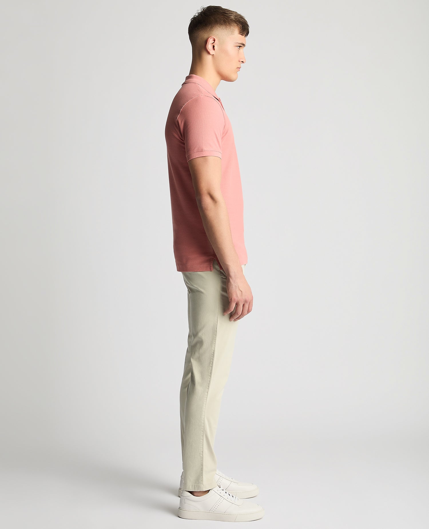 Man wearing a red Tapered Fit Cotton Pique Polo Shirt
