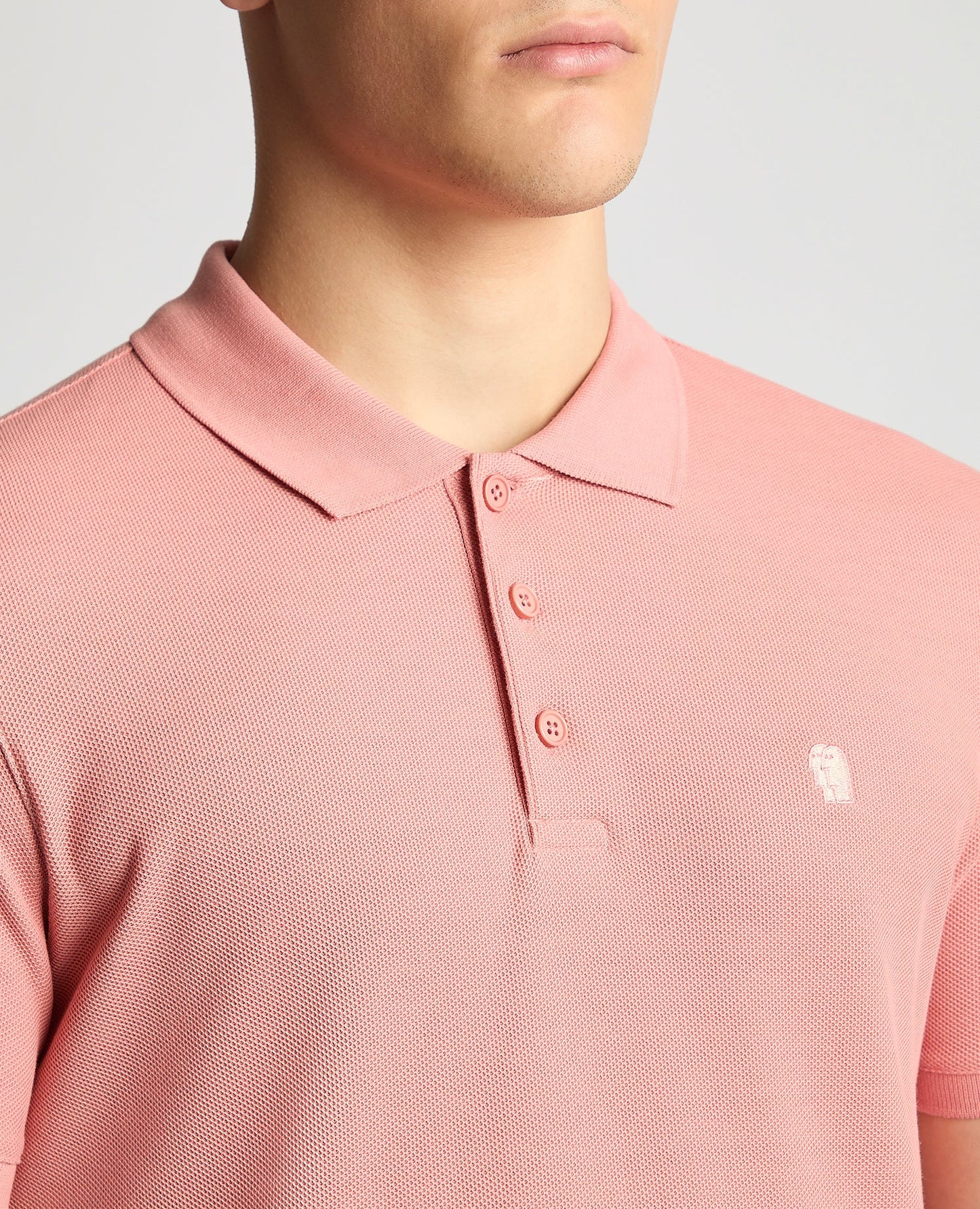 Man wearing a red Tapered Fit Cotton Pique Polo Shirt