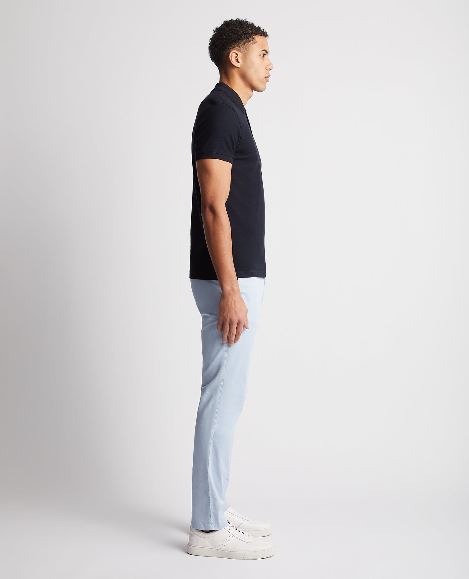 Man wearing a navy Tapered Fit Cotton Pique Polo Shirt