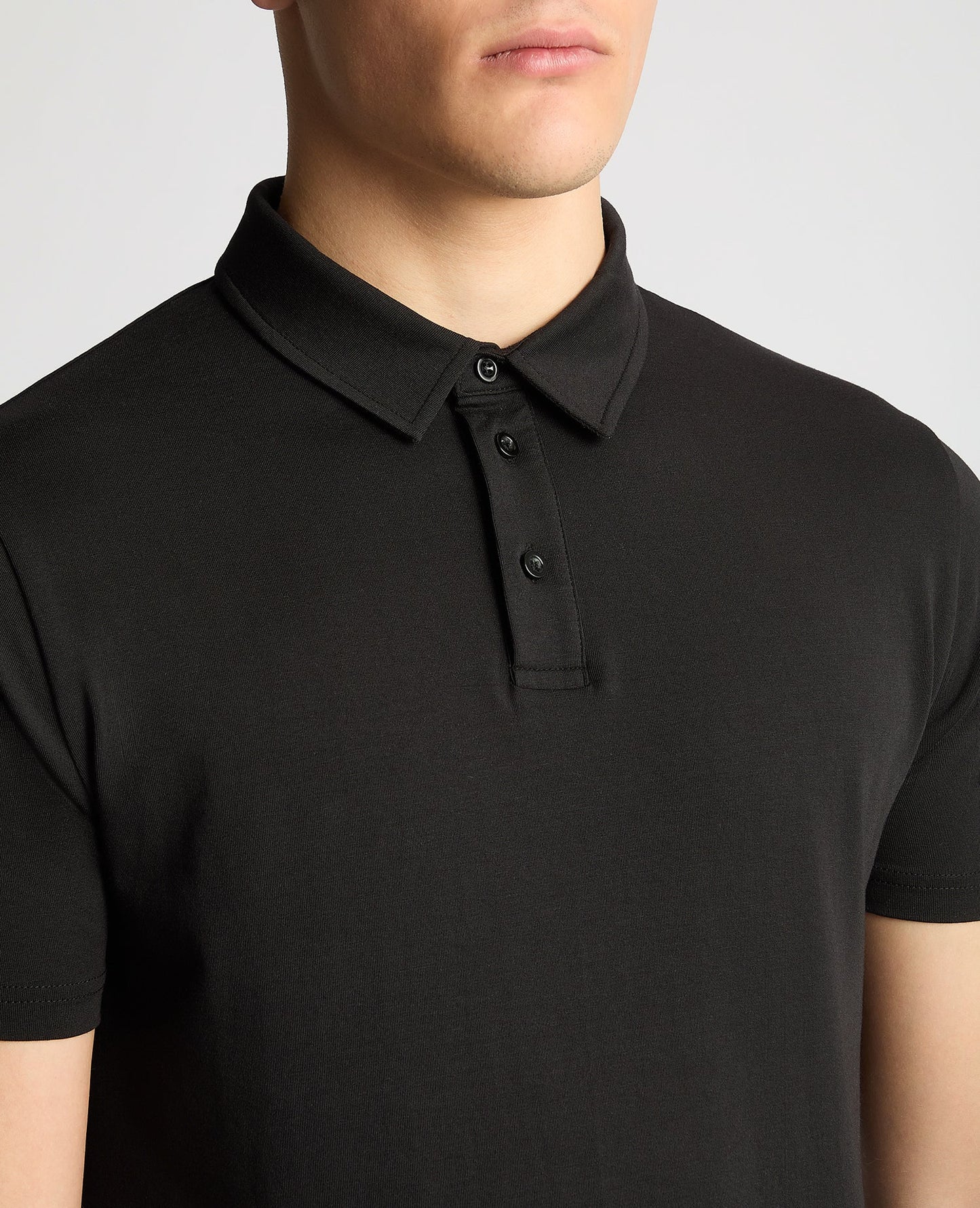 Man wearing a black Relaxed Fit Tencel Polo