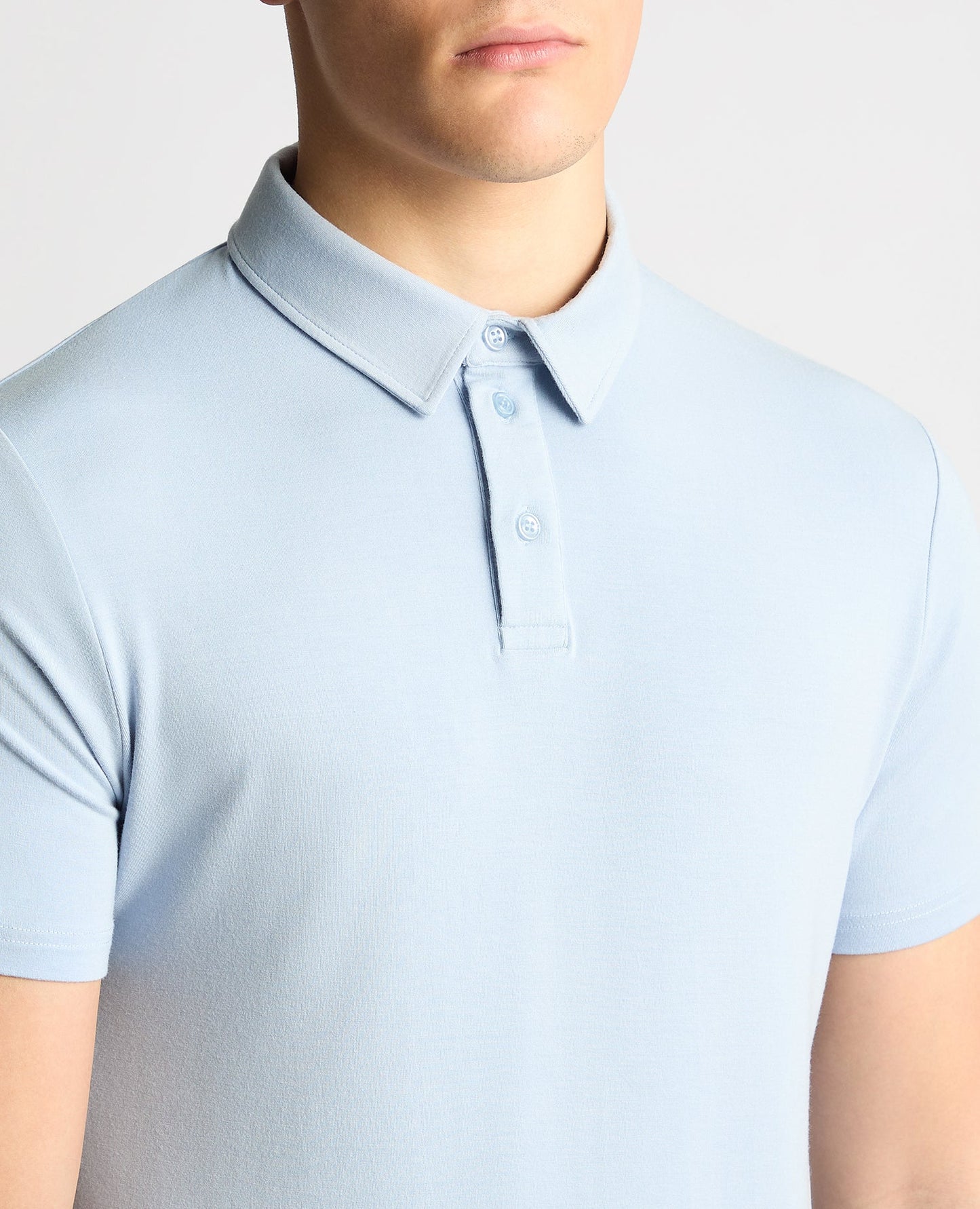 Man wearing a blue Relaxed Fit Tencel Polo