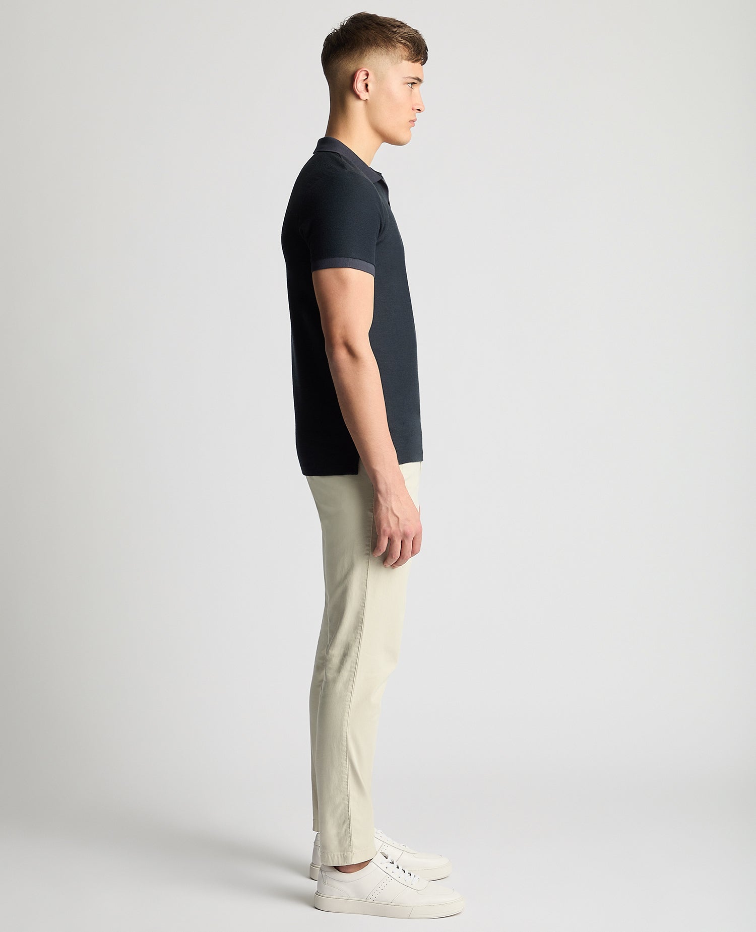 Man wearing a navy Tapered Fit Open Collar Polo