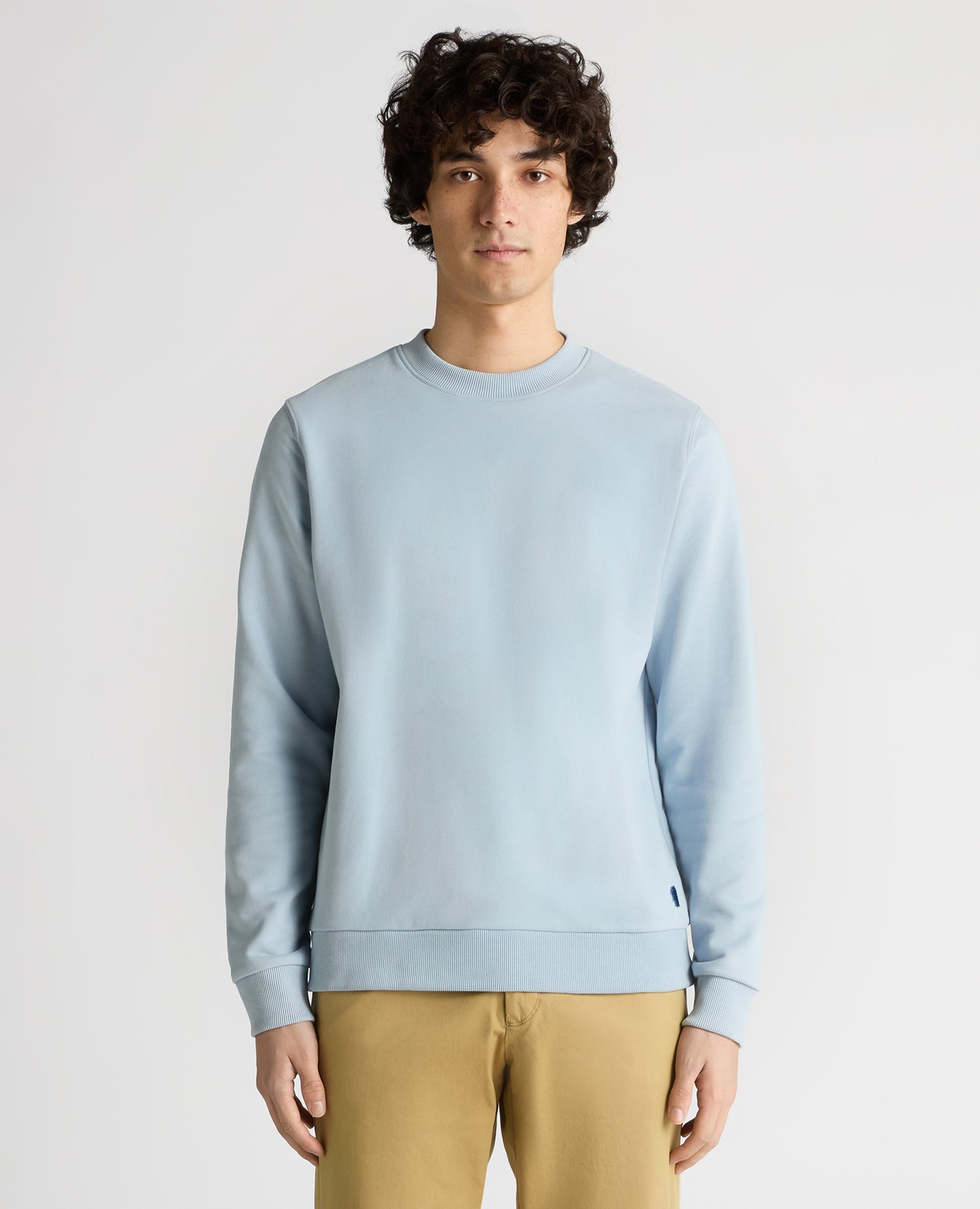 Man wearing a blue Tapered Fit Soft Touch Cotton-Blend Sweatshirt