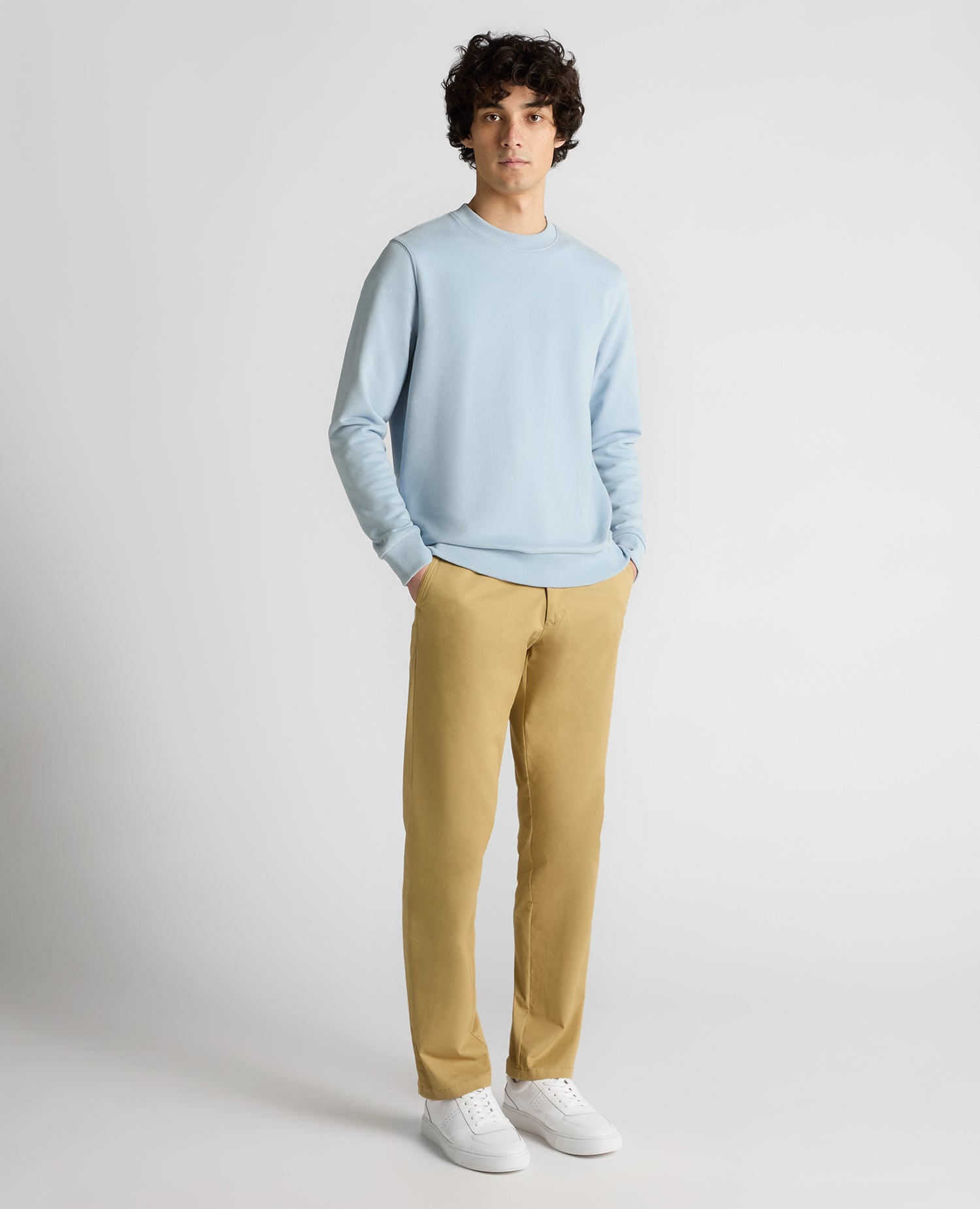 Man wearing a blue Tapered Fit Soft Touch Cotton-Blend Sweatshirt