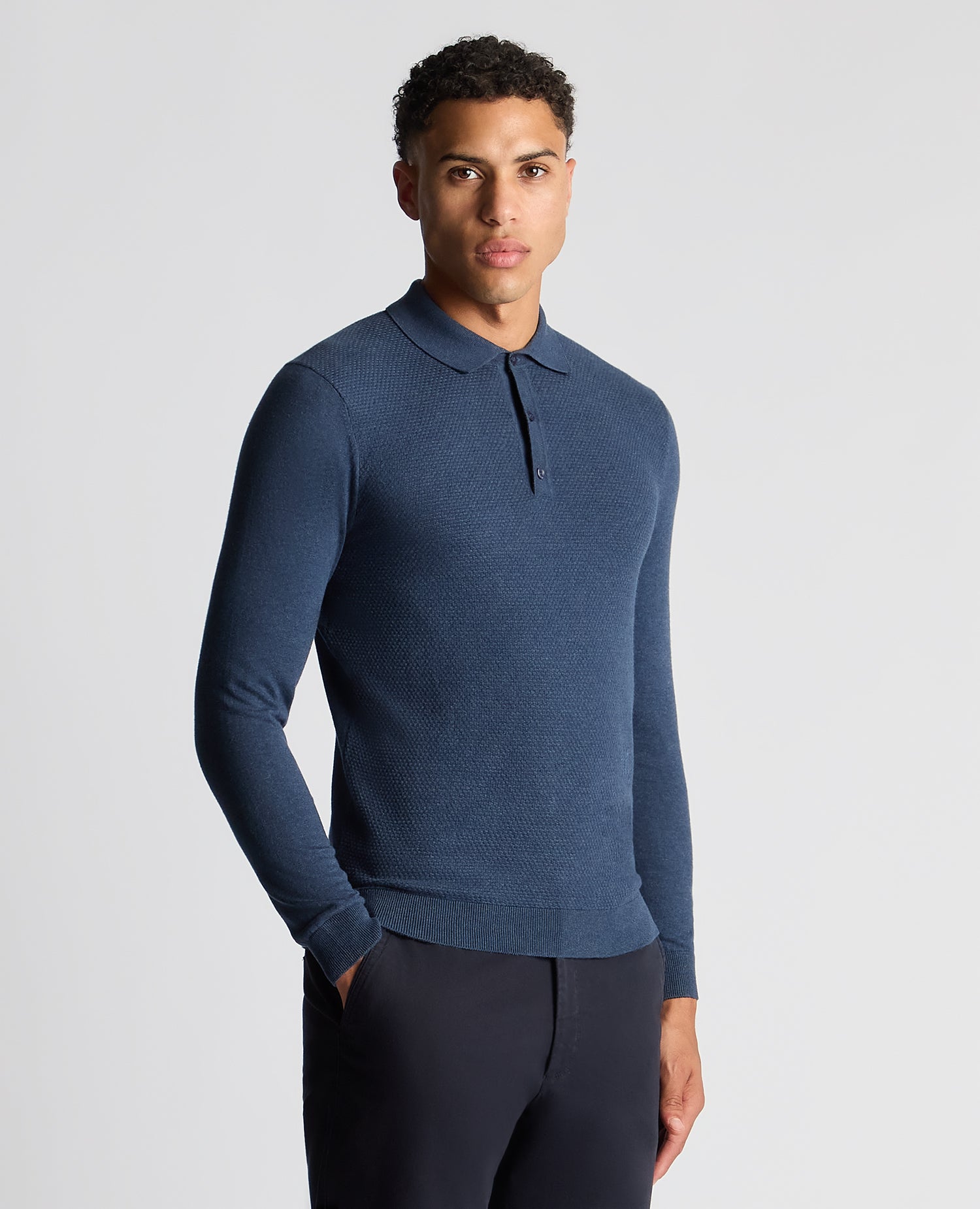 Man wearing a blue Slim Fit Cotton Knitted Polo