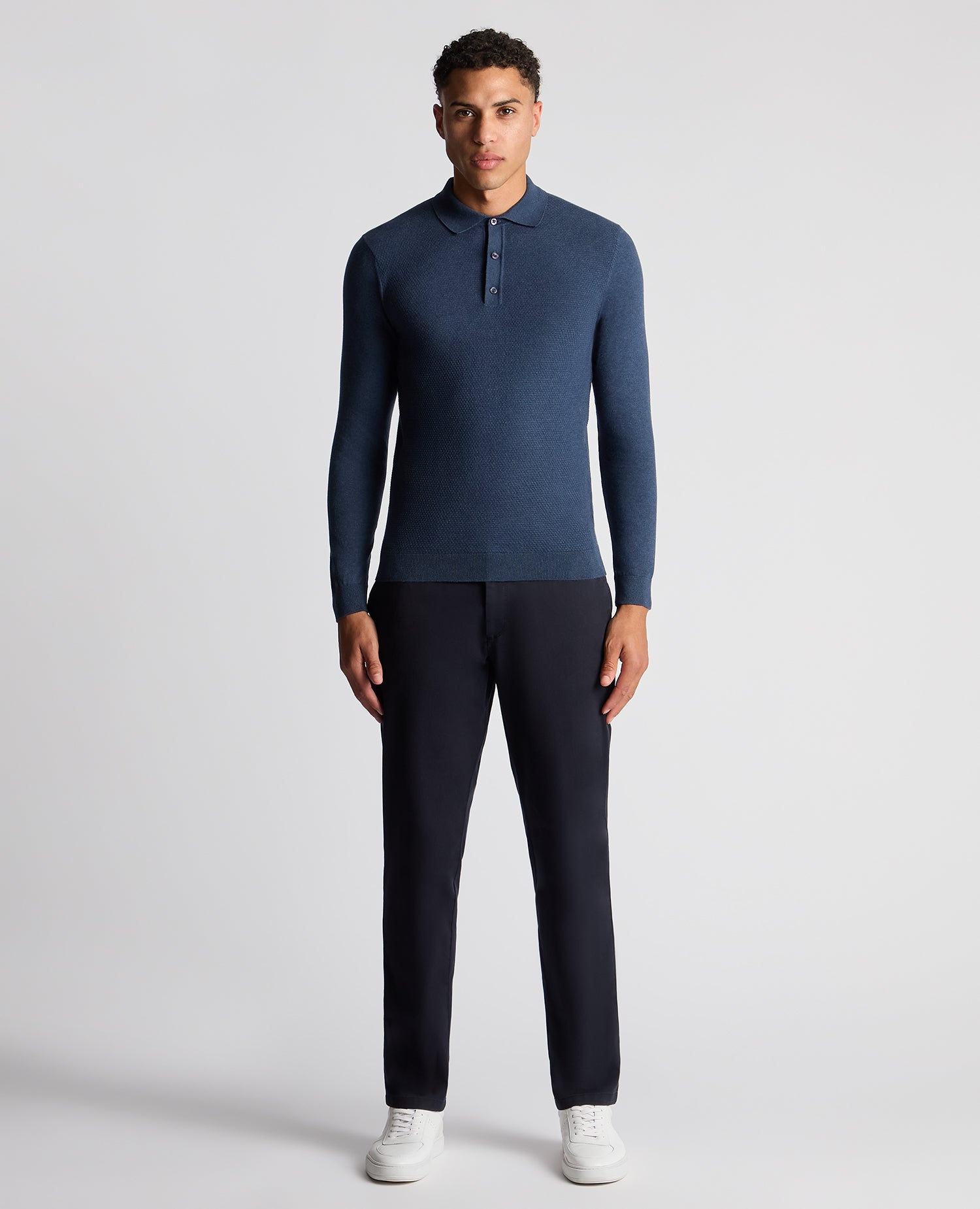 Man wearing a blue Slim Fit Cotton Knitted Polo