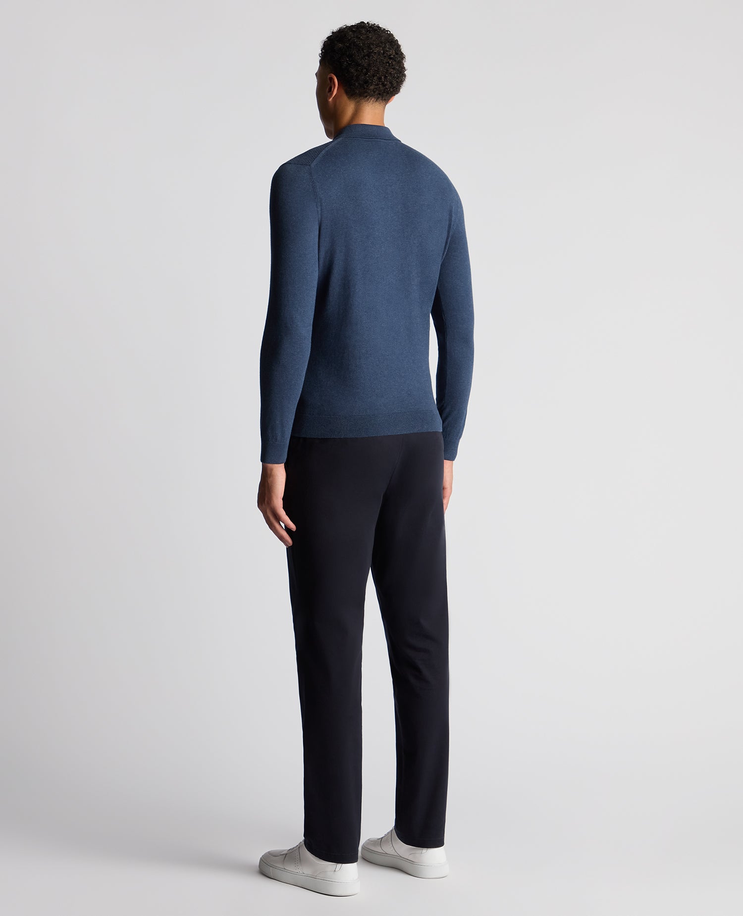 Man wearing a blue Slim Fit Cotton Knitted Polo