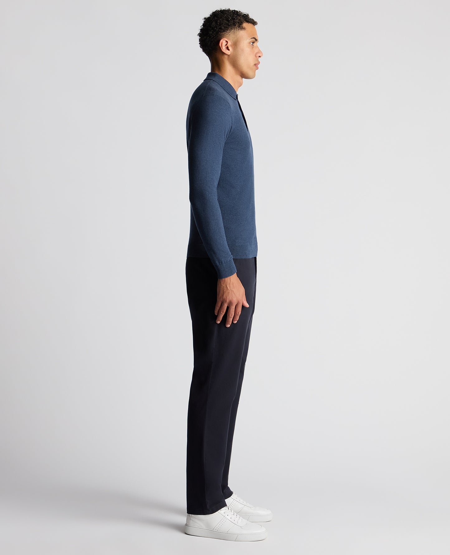 Man wearing a blue Slim Fit Cotton Knitted Polo