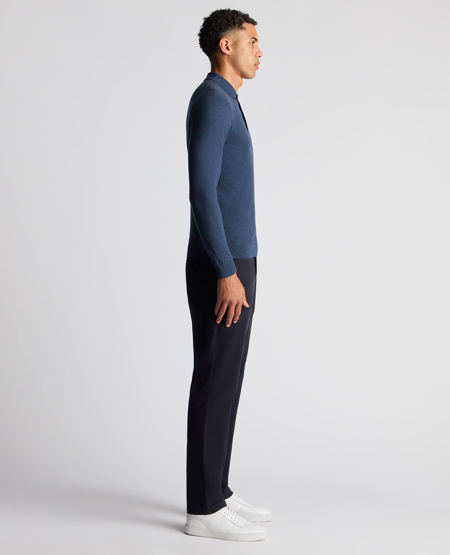 Man wearing a blue Slim Fit Cotton Knitted Polo