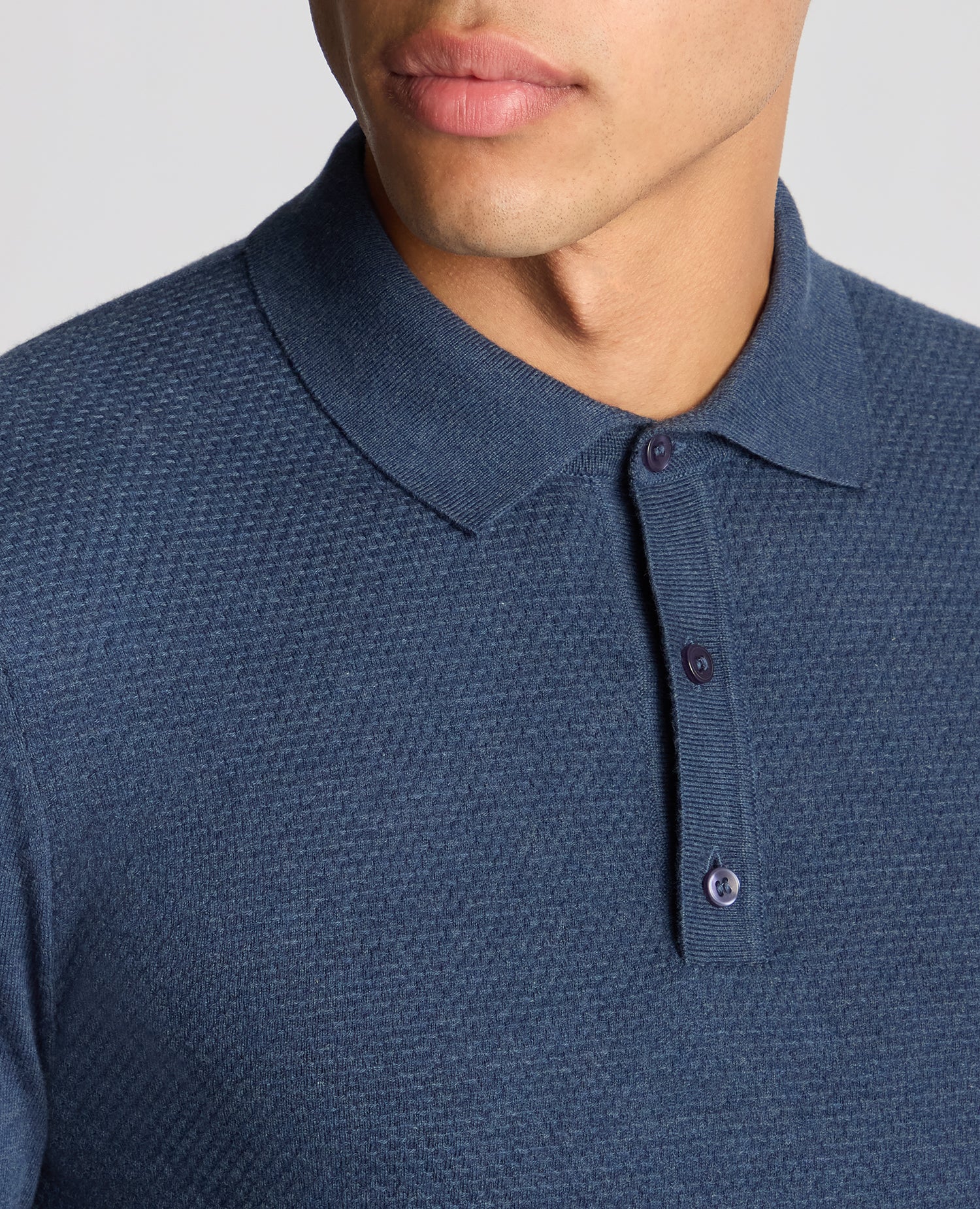 Man wearing a blue Slim Fit Cotton Knitted Polo