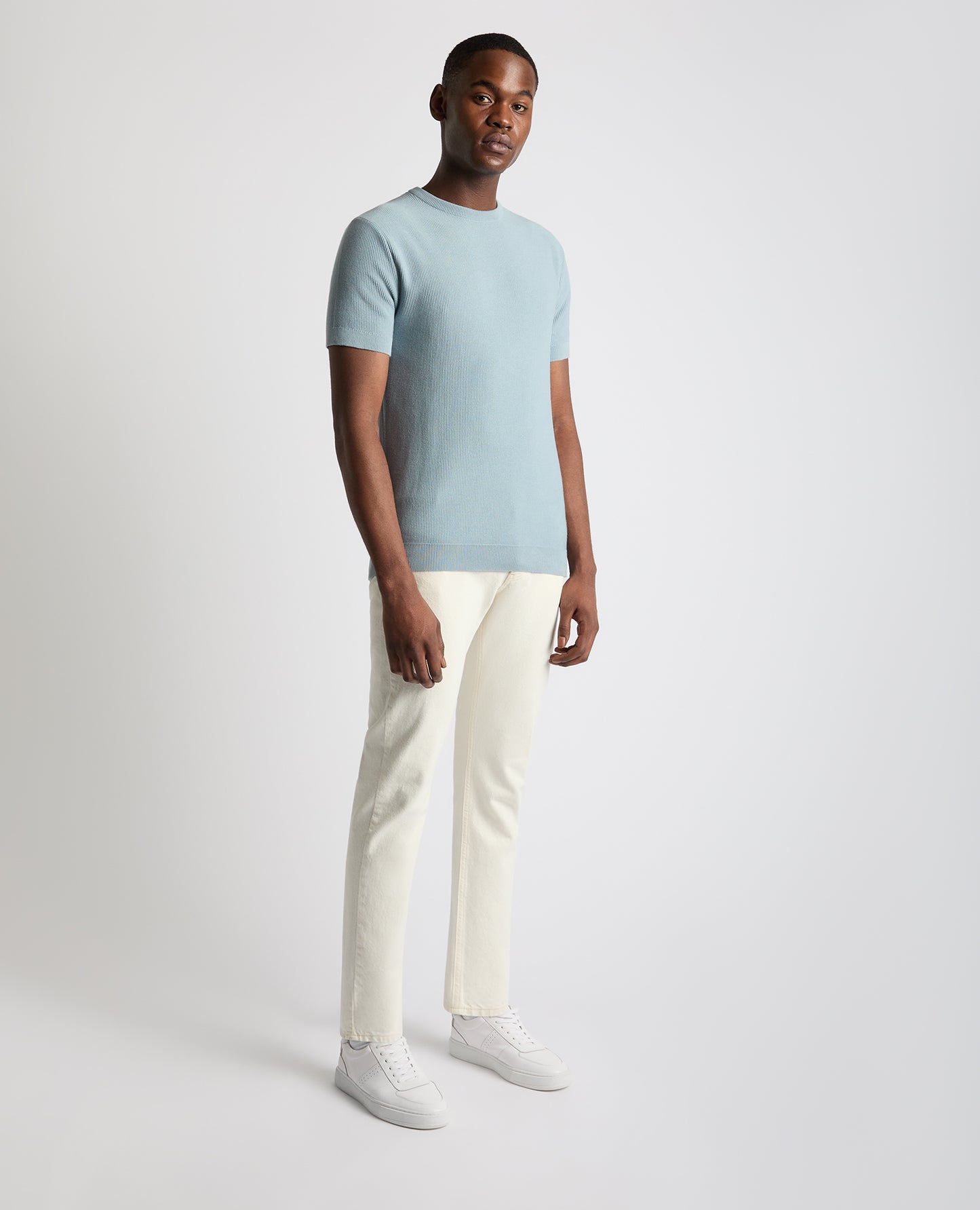 Man wearing a blue Slim Fit Wafffle Knitted Tee