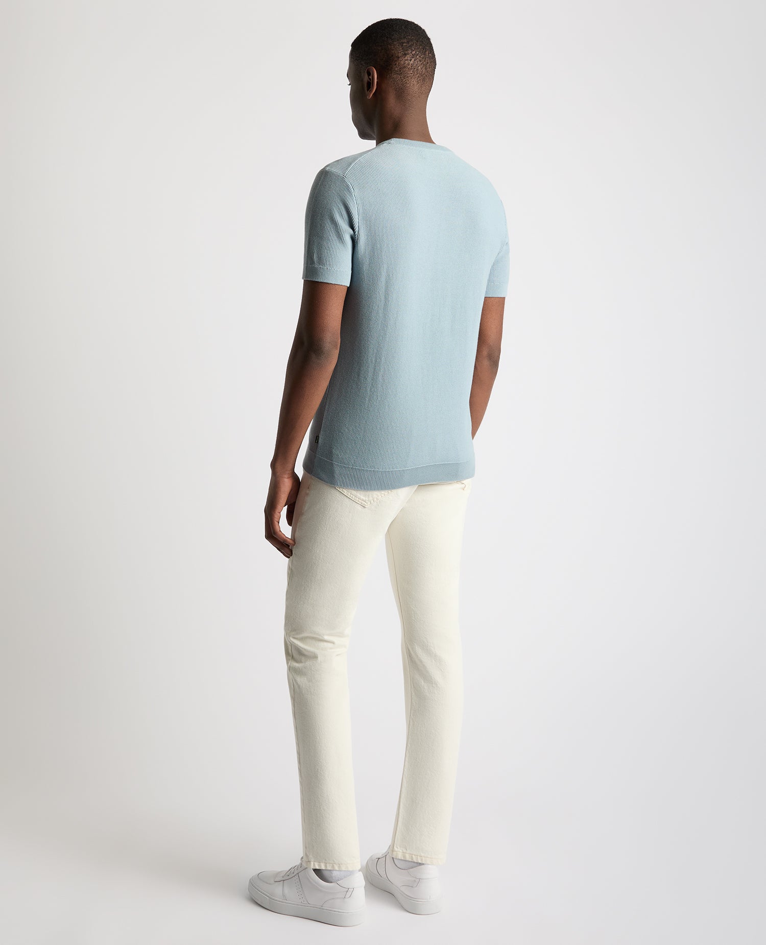 Man wearing a blue Slim Fit Wafffle Knitted Tee