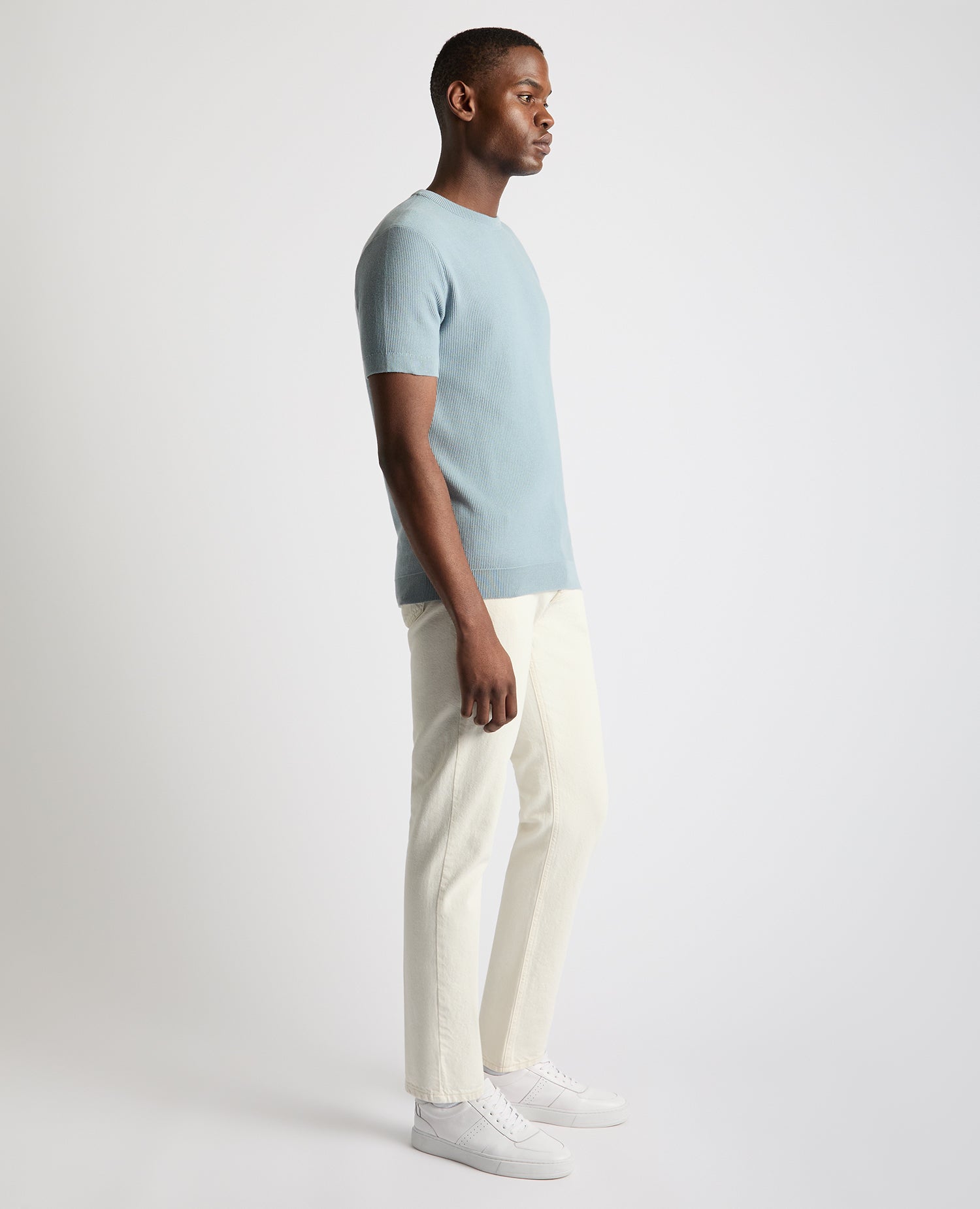 Man wearing a blue Slim Fit Wafffle Knitted Tee