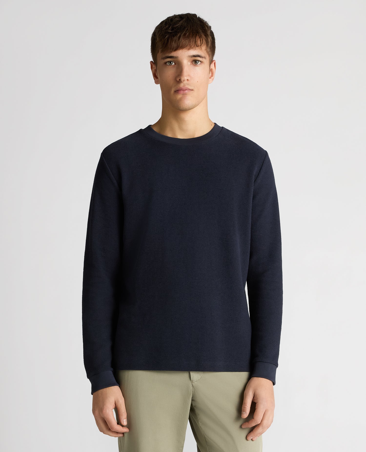 Man wearing a navy Tapered Fit Cotton Micro Waffle Sweatshirt