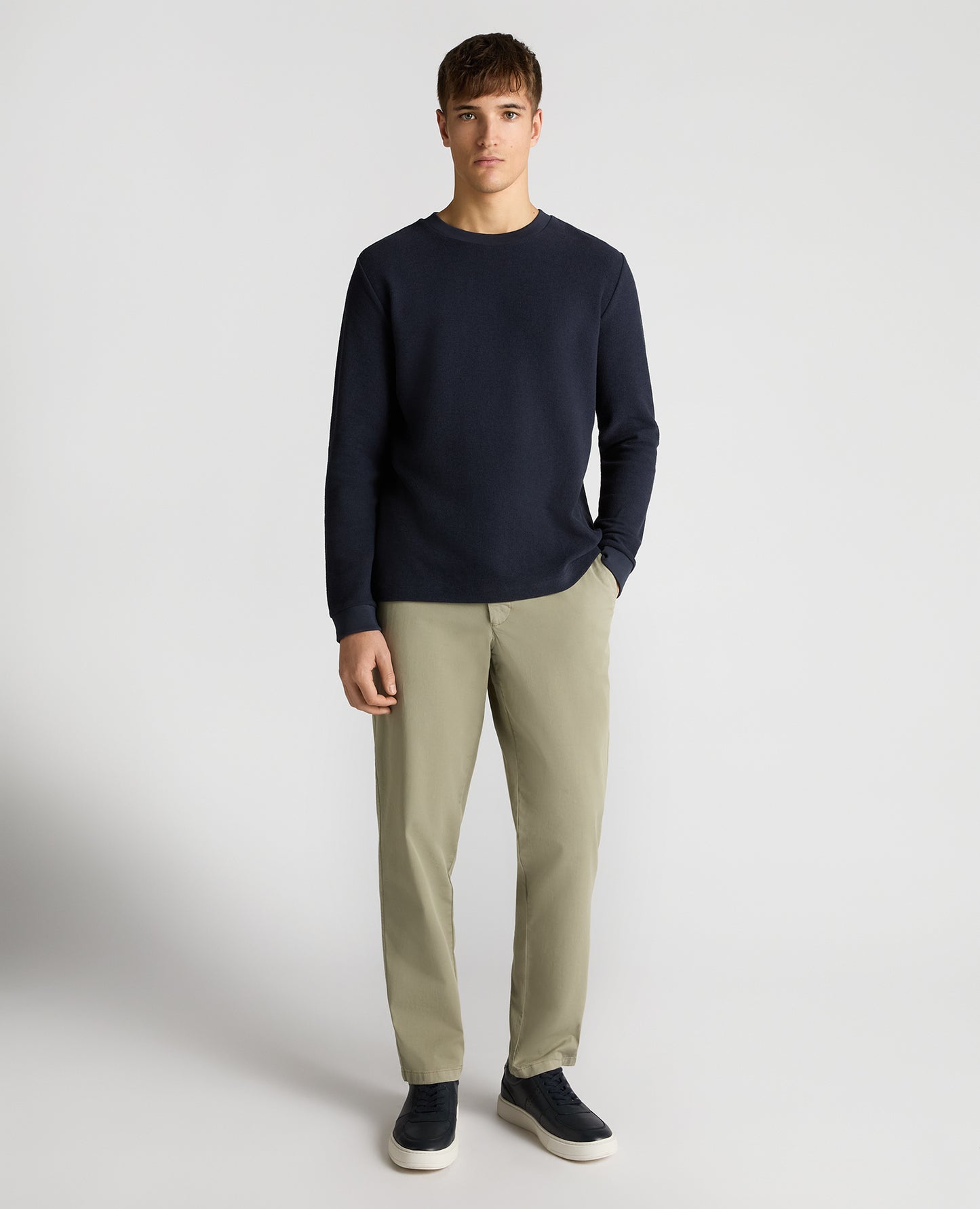Man wearing a navy Tapered Fit Cotton Micro Waffle Sweatshirt