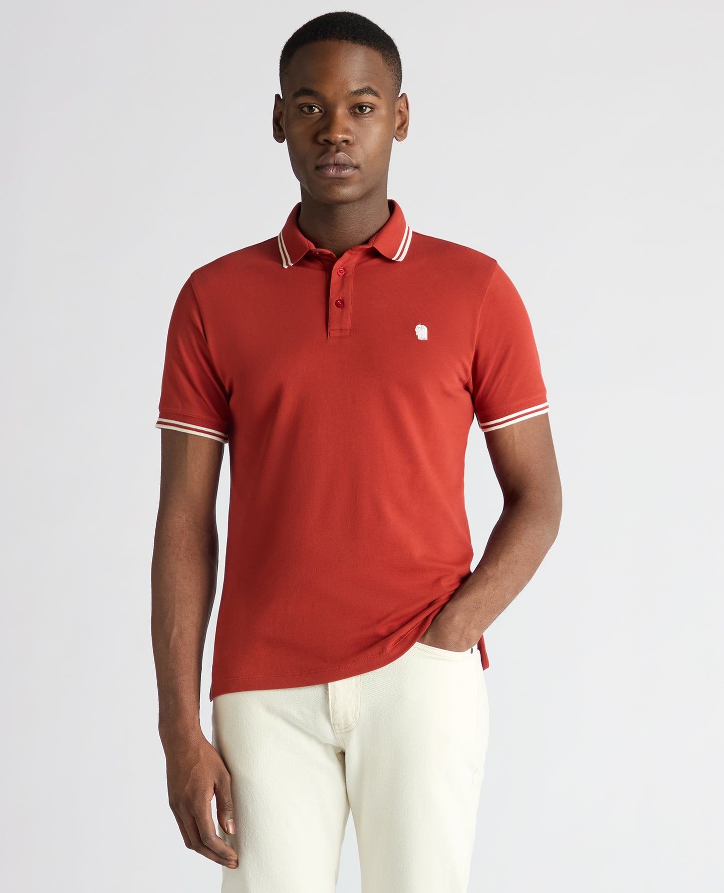 Man wearing a orange Tapered Fit Cotton-Stretch Polo Shirt