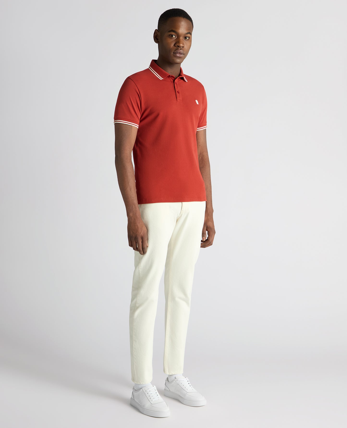 Man wearing a orange Tapered Fit Cotton-Stretch Polo Shirt