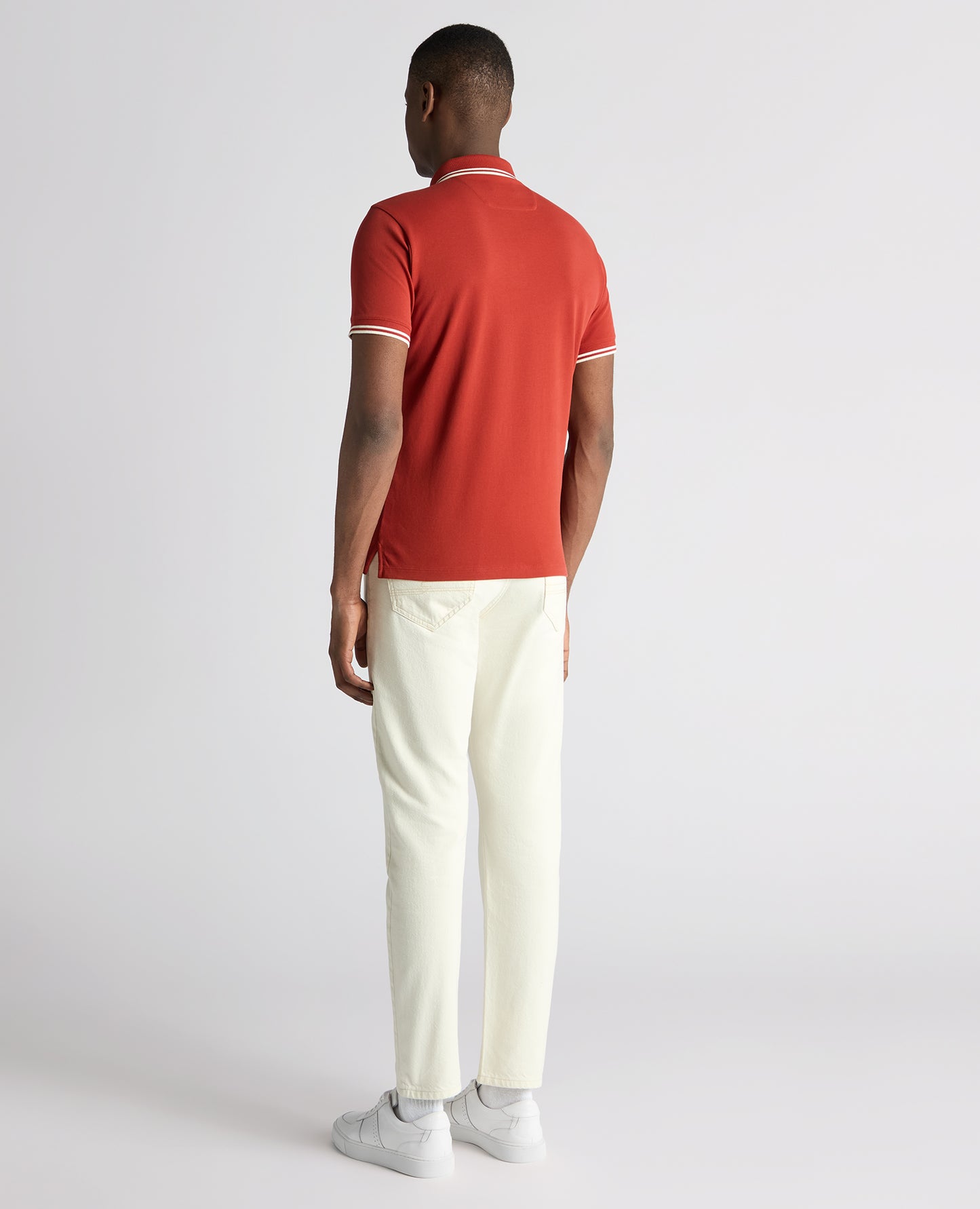 Man wearing a orange Tapered Fit Cotton-Stretch Polo Shirt