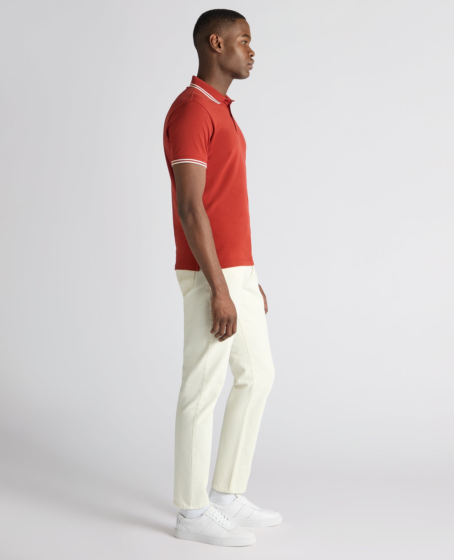 Man wearing a orange Tapered Fit Cotton-Stretch Polo Shirt