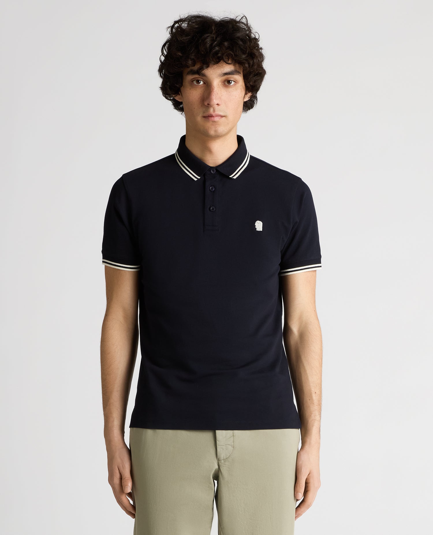Man wearing a navy Tapered Fit Cotton-Stretch Polo Shirt