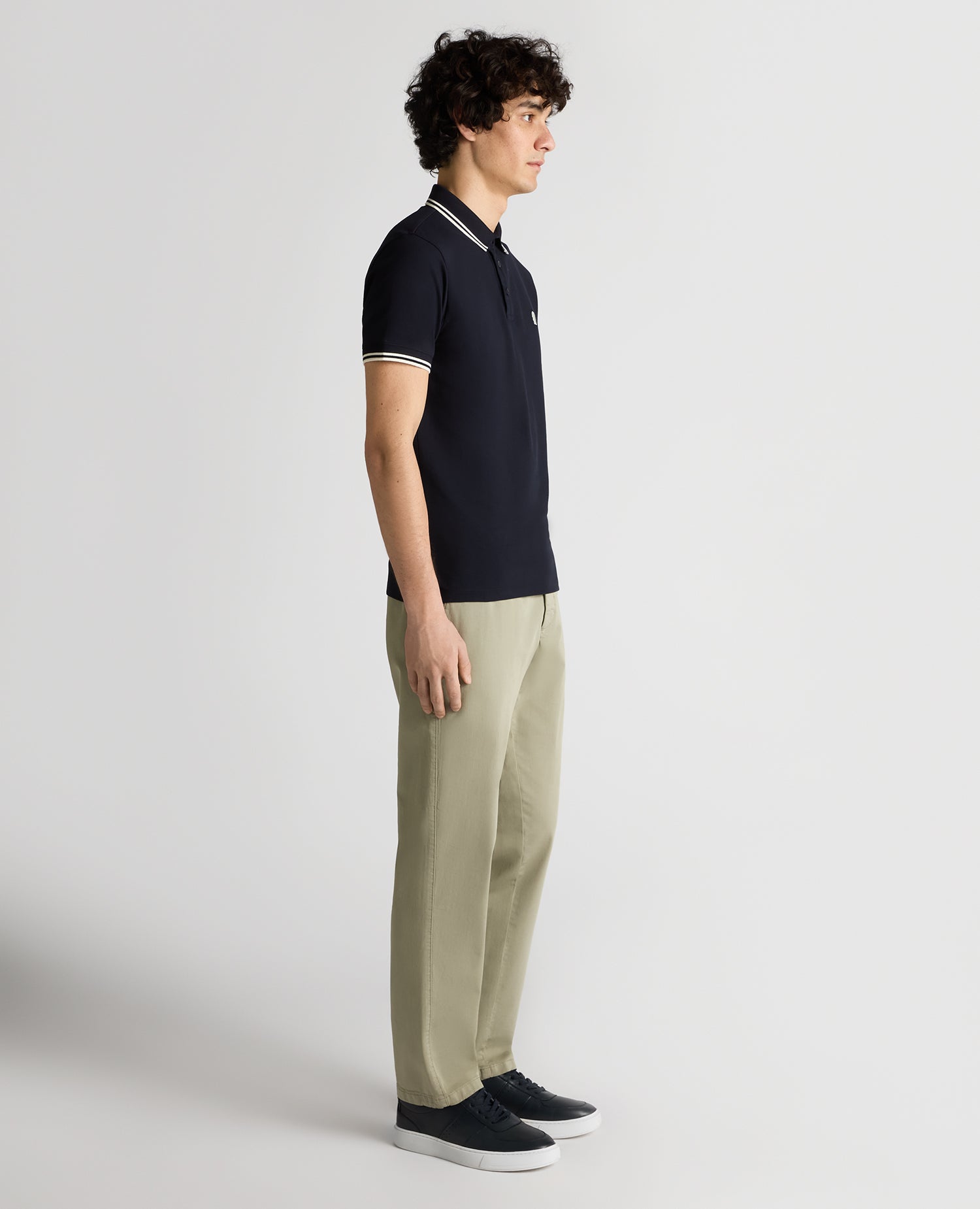 Man wearing a navy Tapered Fit Cotton-Stretch Polo Shirt