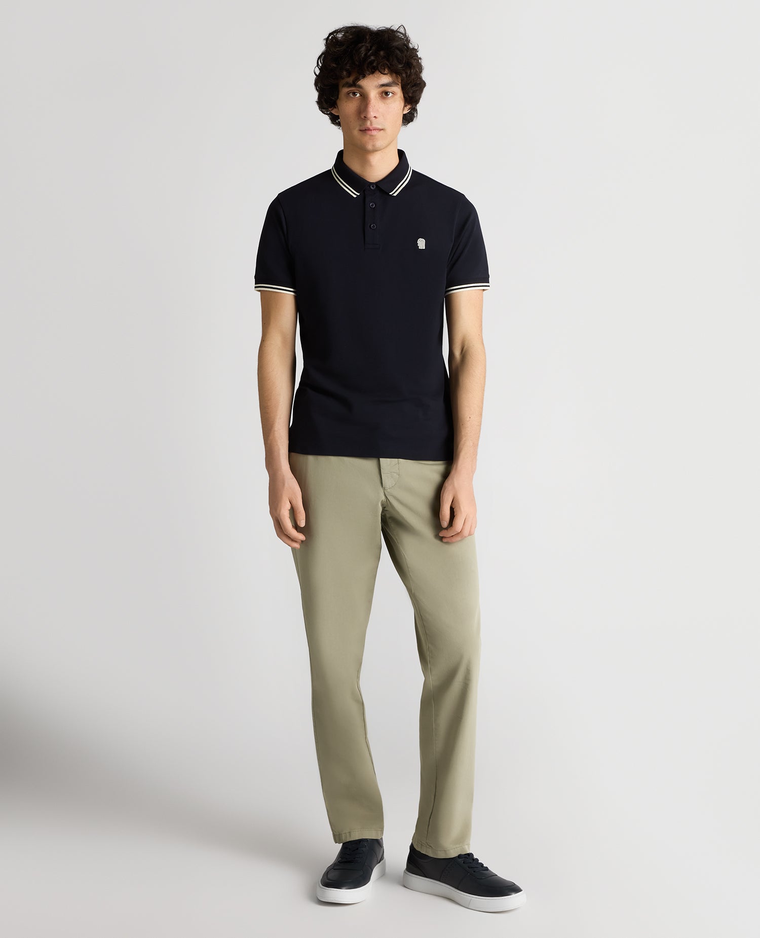 Man wearing a navy Tapered Fit Cotton-Stretch Polo Shirt
