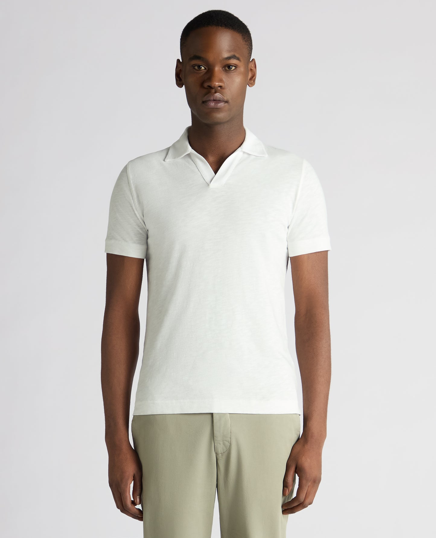 Man wearing a white Tapered Fit Open Collar Cotton Polo