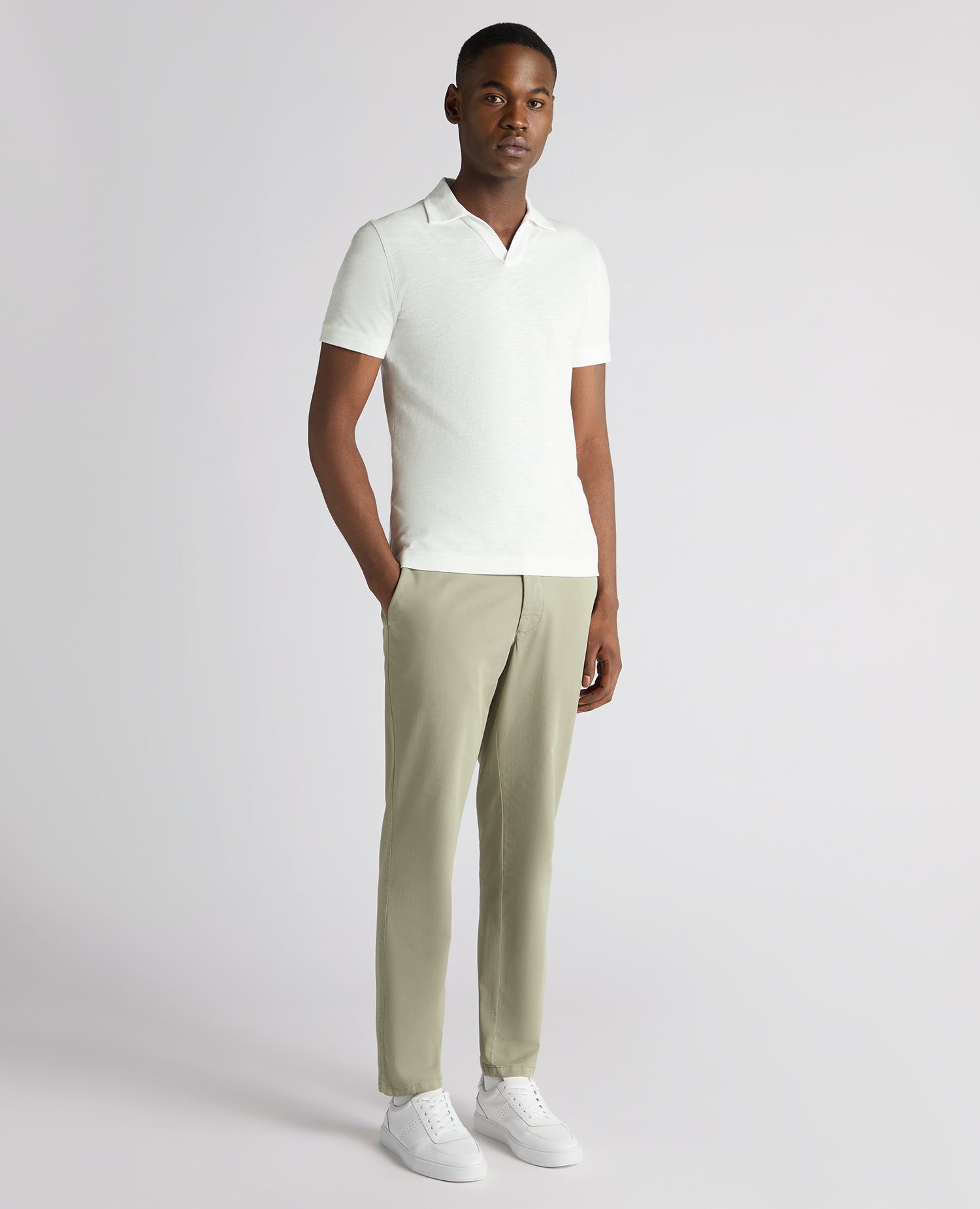 Man wearing a white Tapered Fit Open Collar Cotton Polo