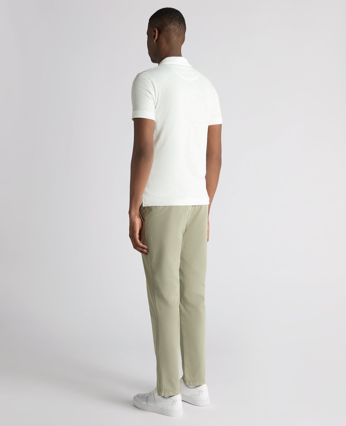 Man wearing a white Tapered Fit Open Collar Cotton Polo