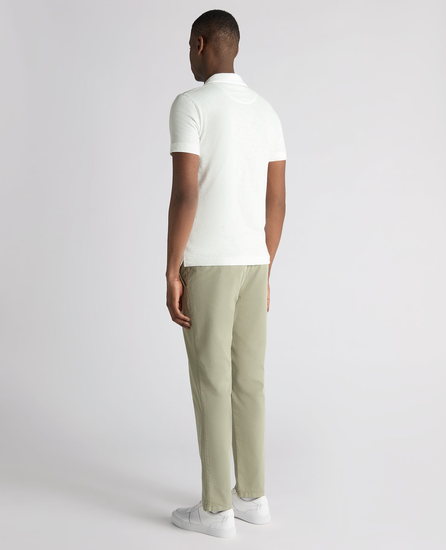 Man wearing a white Tapered Fit Open Collar Cotton Polo