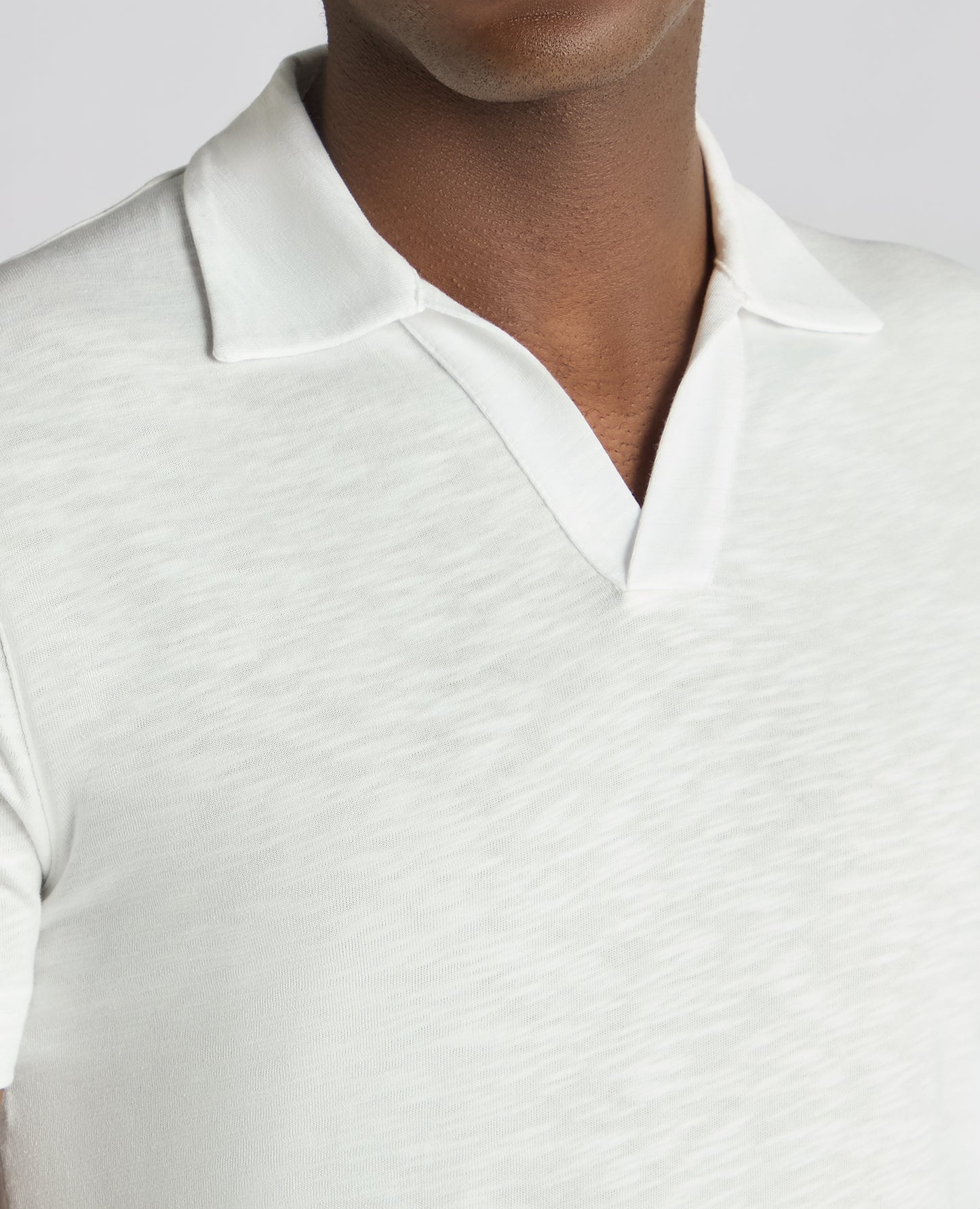 Man wearing a white Tapered Fit Open Collar Cotton Polo