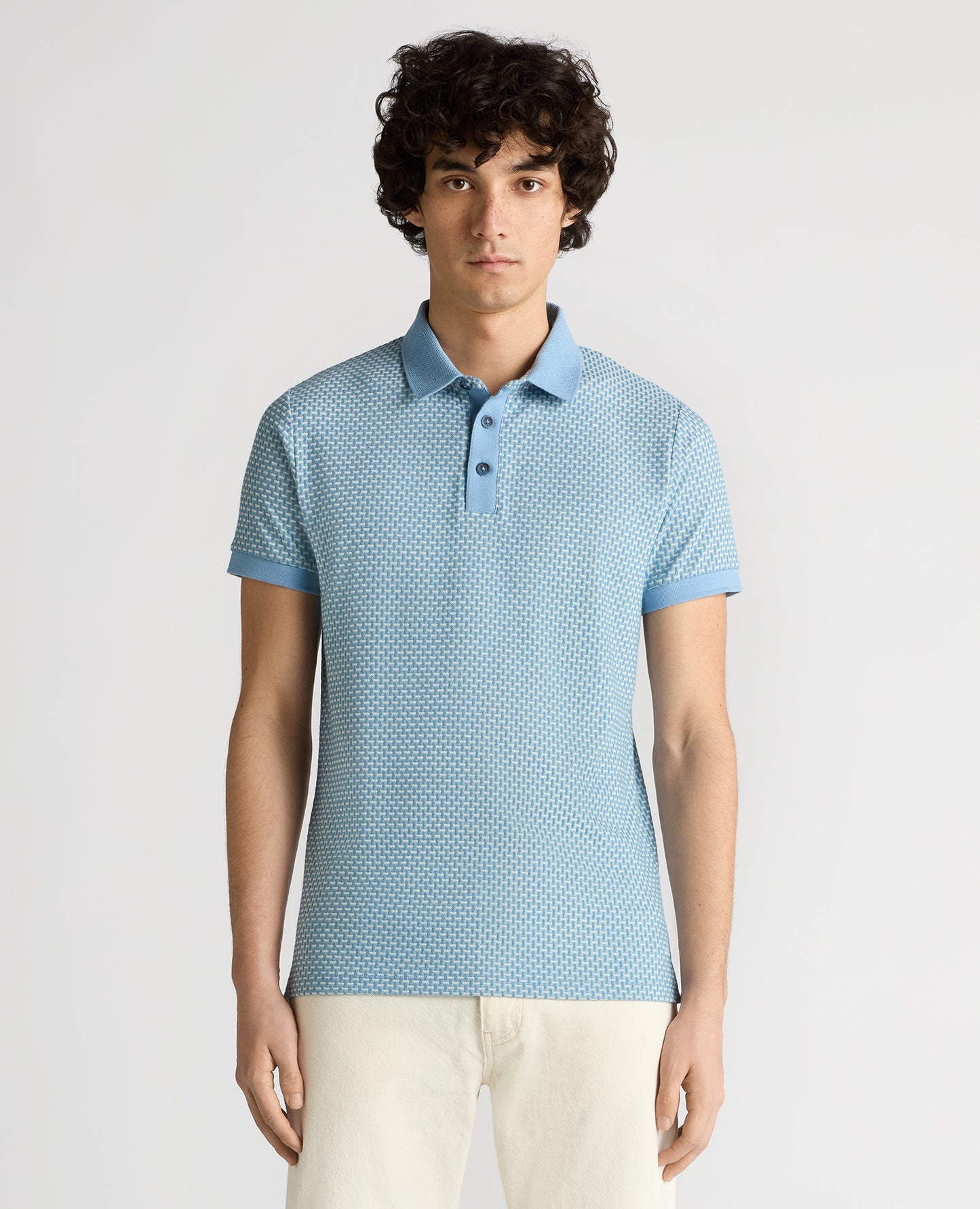 Man wearing a blue Tapered Fit Basket Weave Polo Shirt