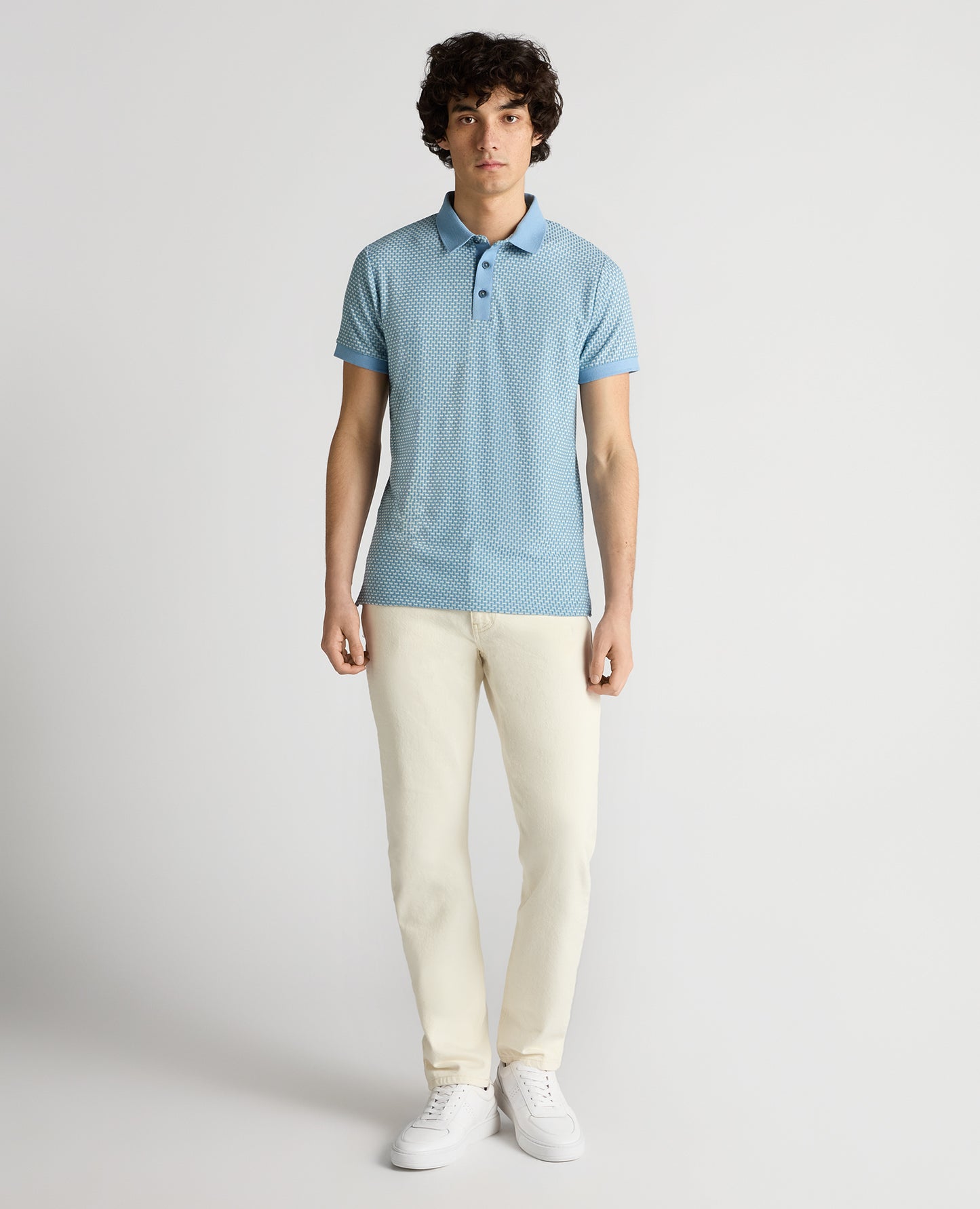 Man wearing a blue Tapered Fit Basket Weave Polo Shirt