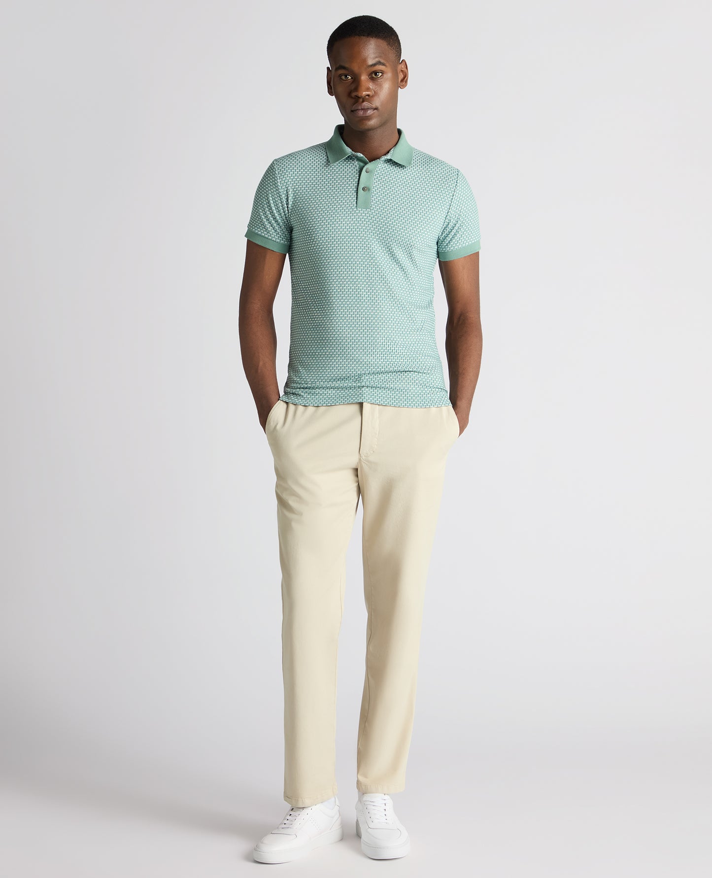 Man wearing a green Tapered Fit Cotton-Blend Polo Shirt