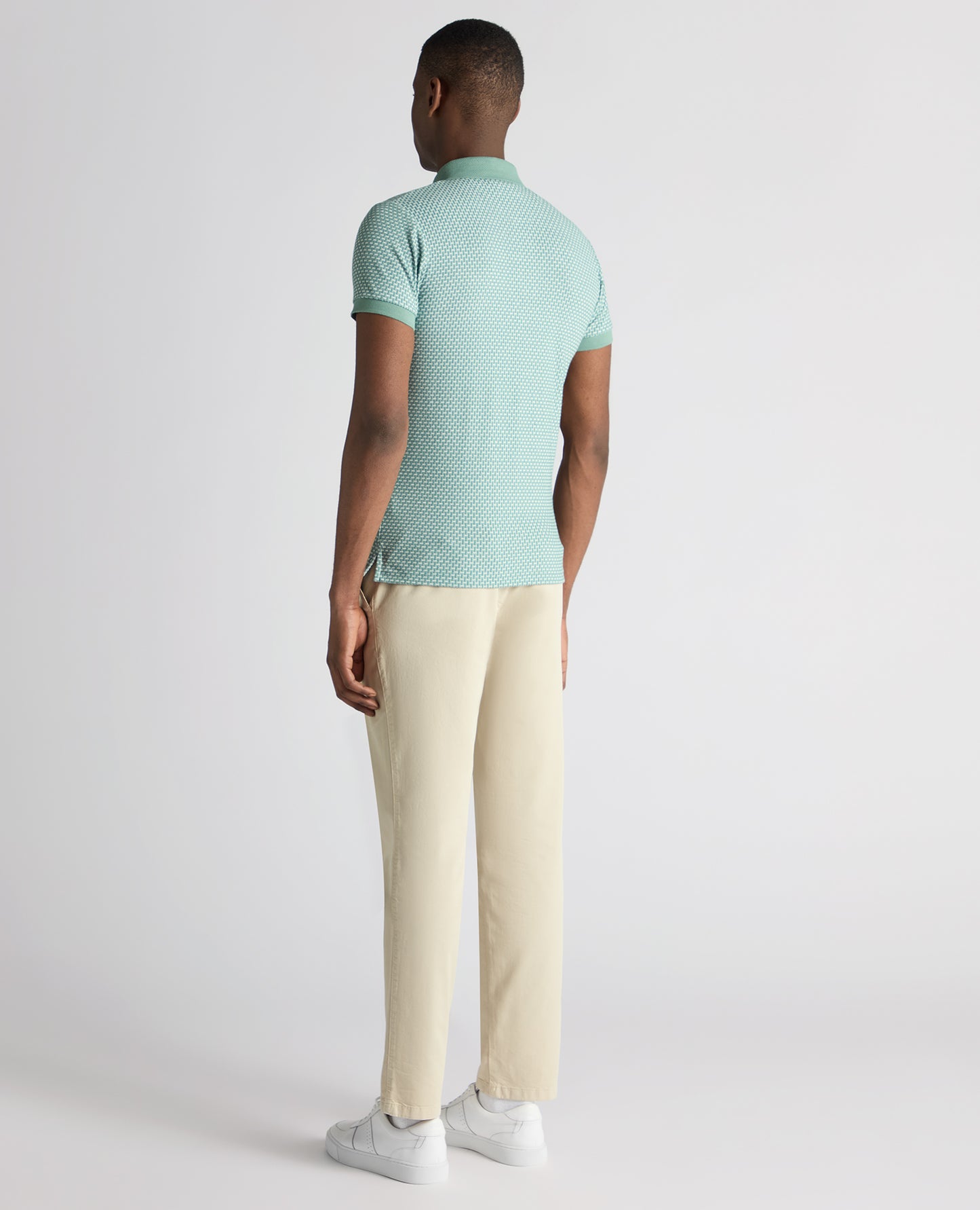 Man wearing a green Tapered Fit Cotton-Blend Polo Shirt