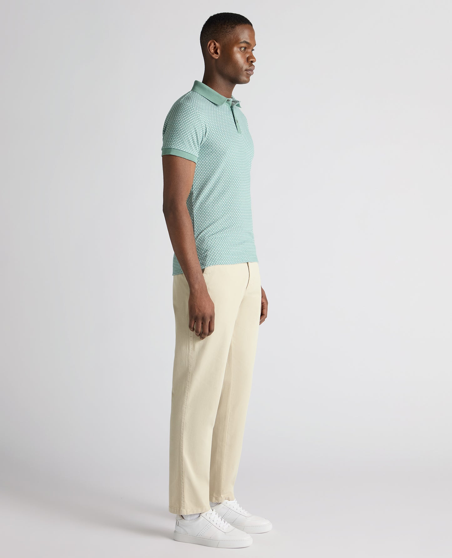 Man wearing a green Tapered Fit Cotton-Blend Polo Shirt