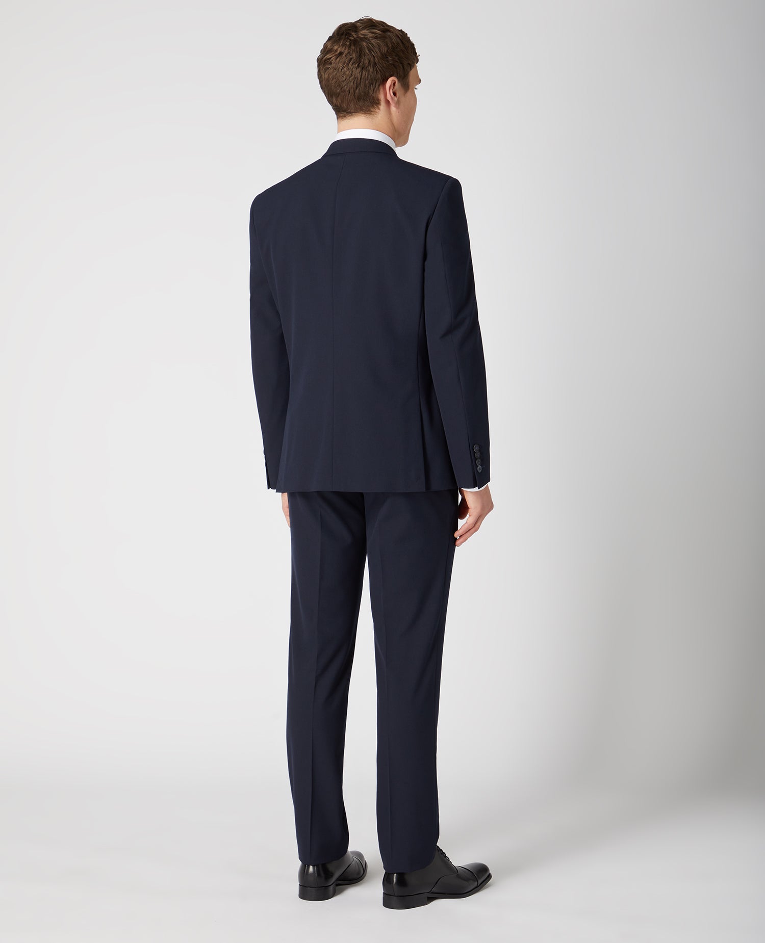 Man wearing a navy Tapered Fit Stretch Mix And Match Suit Jacket