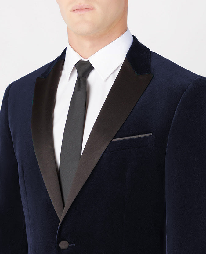 Man wearing a navy Slim Fit Velvet Jacket