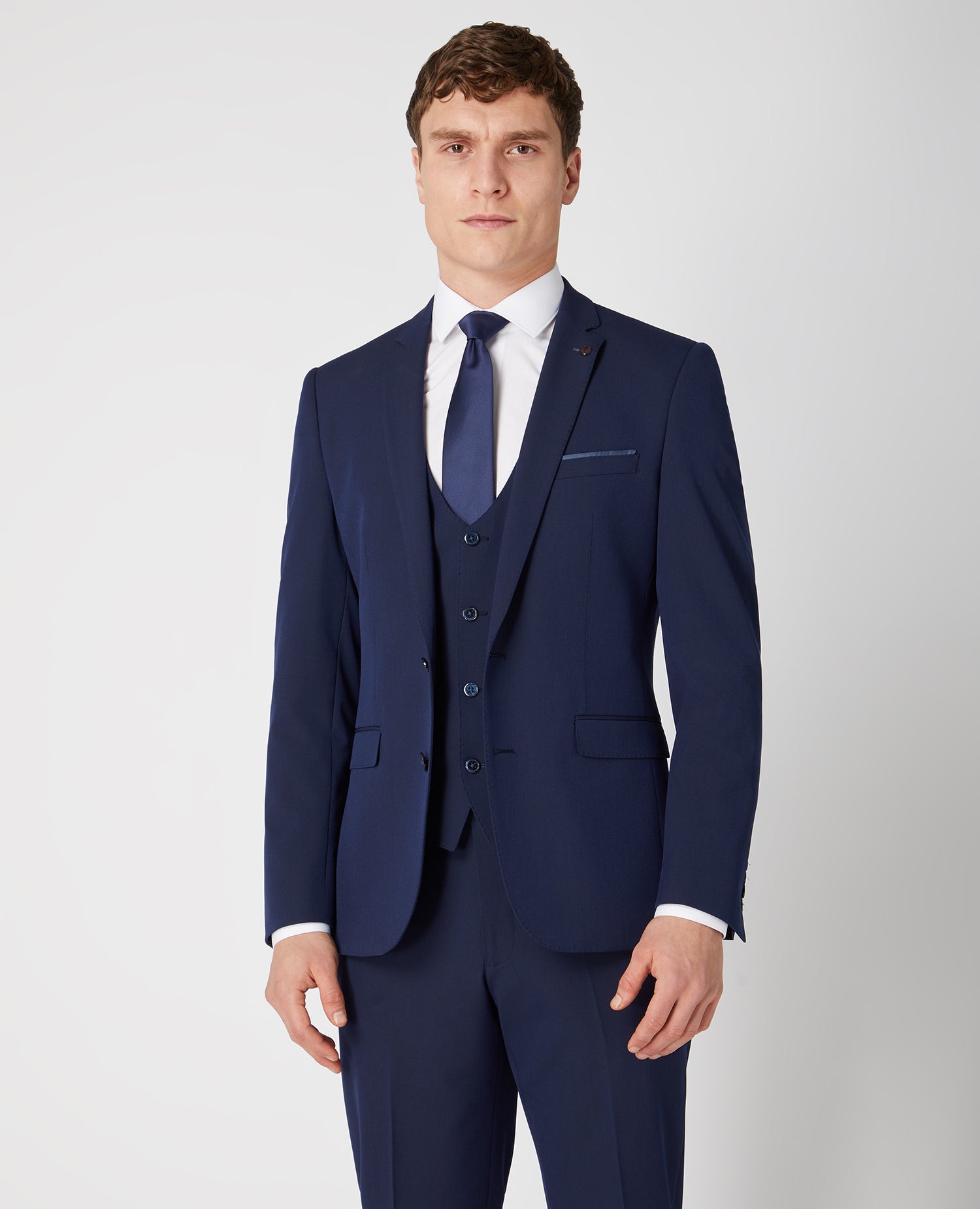 Man wearing a navy Slim Fit Stretch Mix and Match Suit Jacket