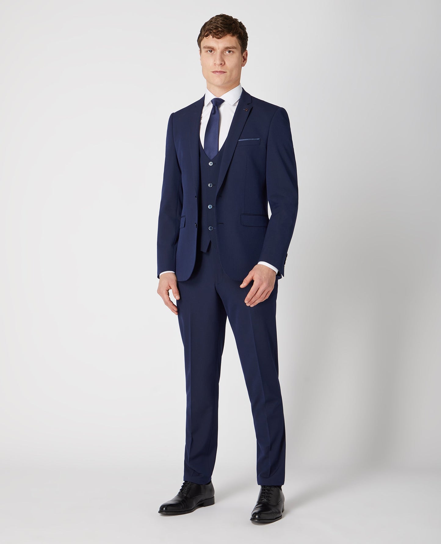 Man wearing a navy Slim Fit Stretch Mix and Match Suit Jacket