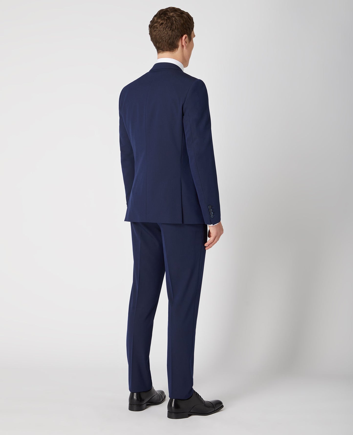 Man wearing a navy Slim Fit Stretch Mix and Match Suit Jacket