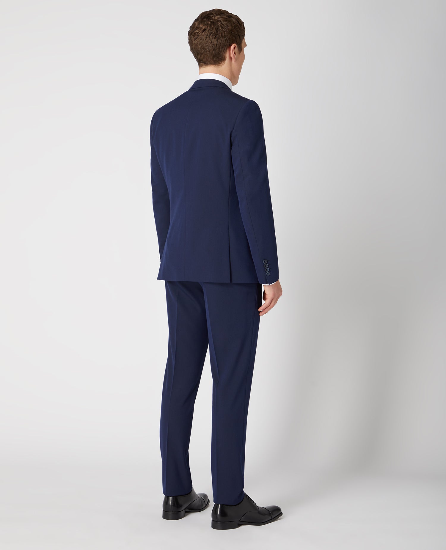 Man wearing a navy Slim Fit Stretch Mix and Match Suit Jacket