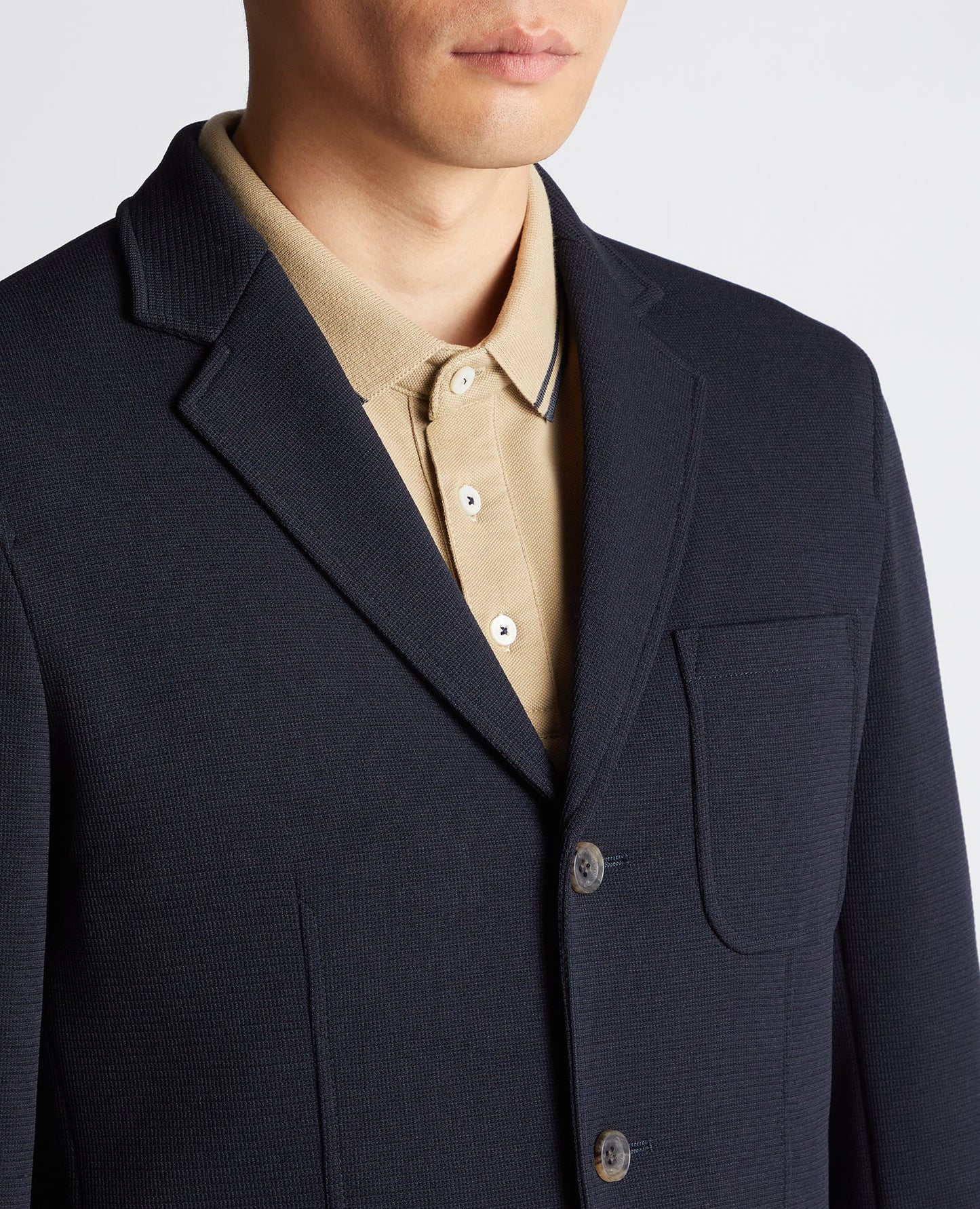Man wearing a navy Slim Fit Cotton-Blend Stretch Jacket