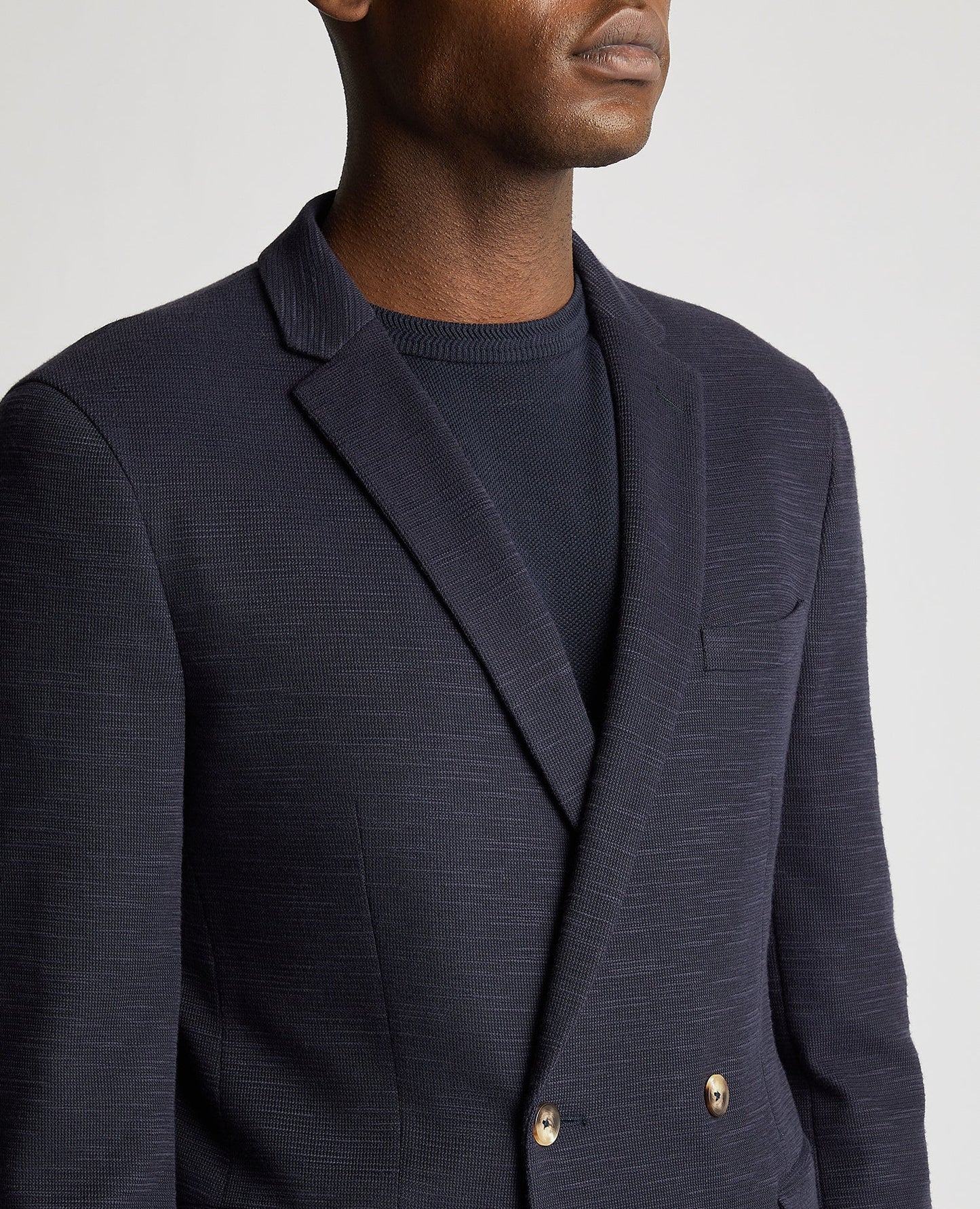 Man wearing a navy Slim Fit Cotton-Stretch Double Breasted Jacket