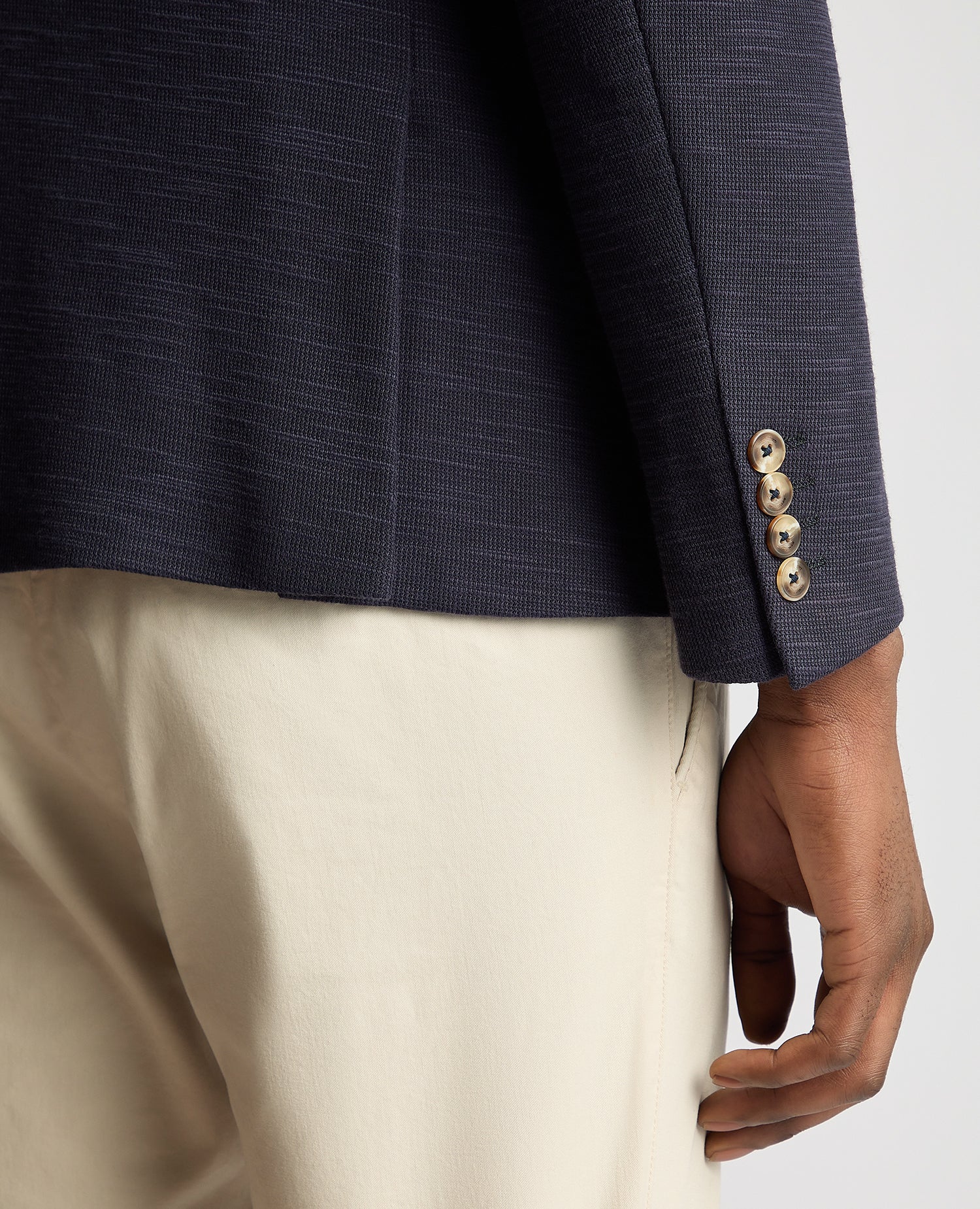 Man wearing a navy Slim Fit Cotton-Stretch Double Breasted Jacket