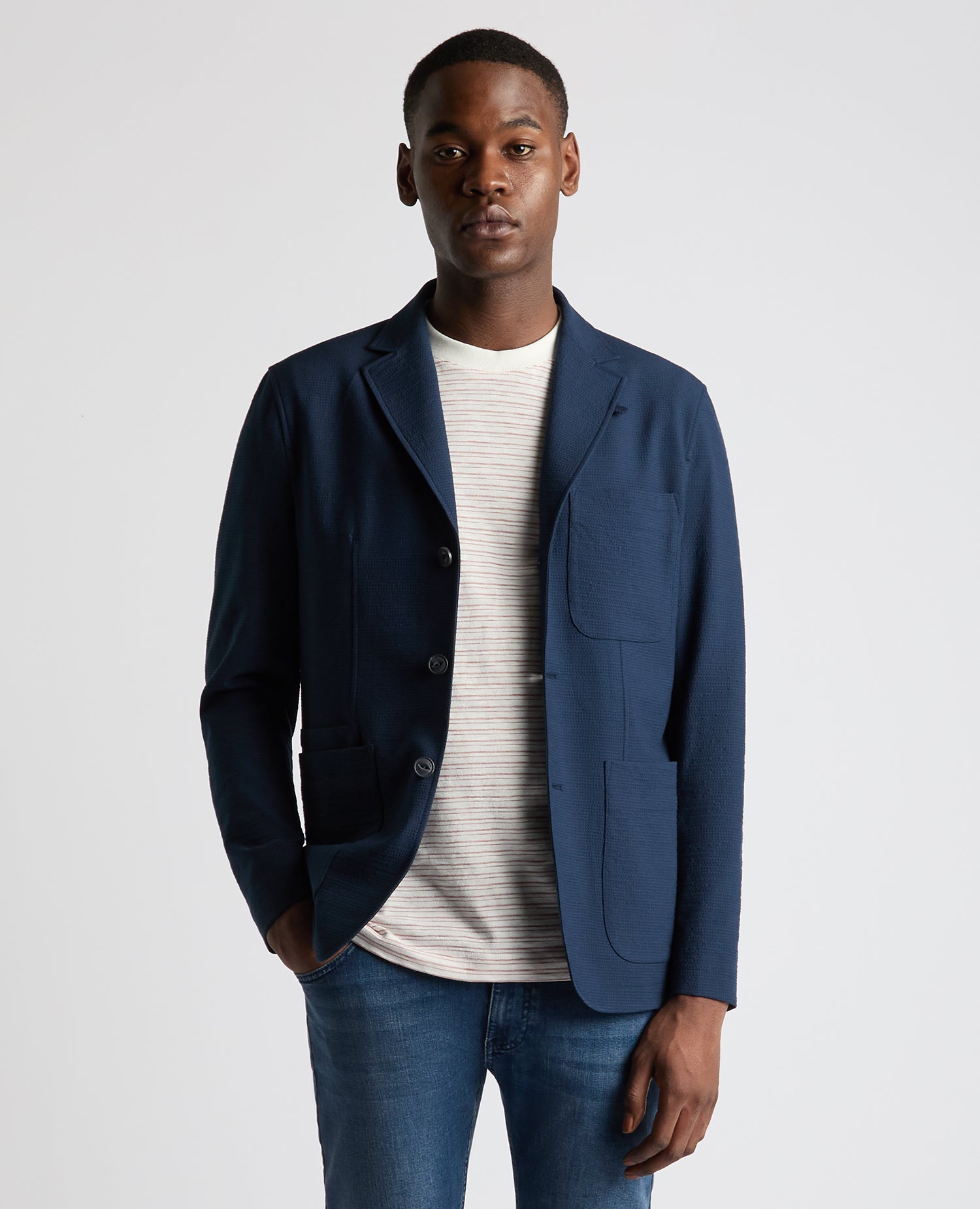 Man wearing a blue Slim Fit Seersucker De-Constructed Jacket