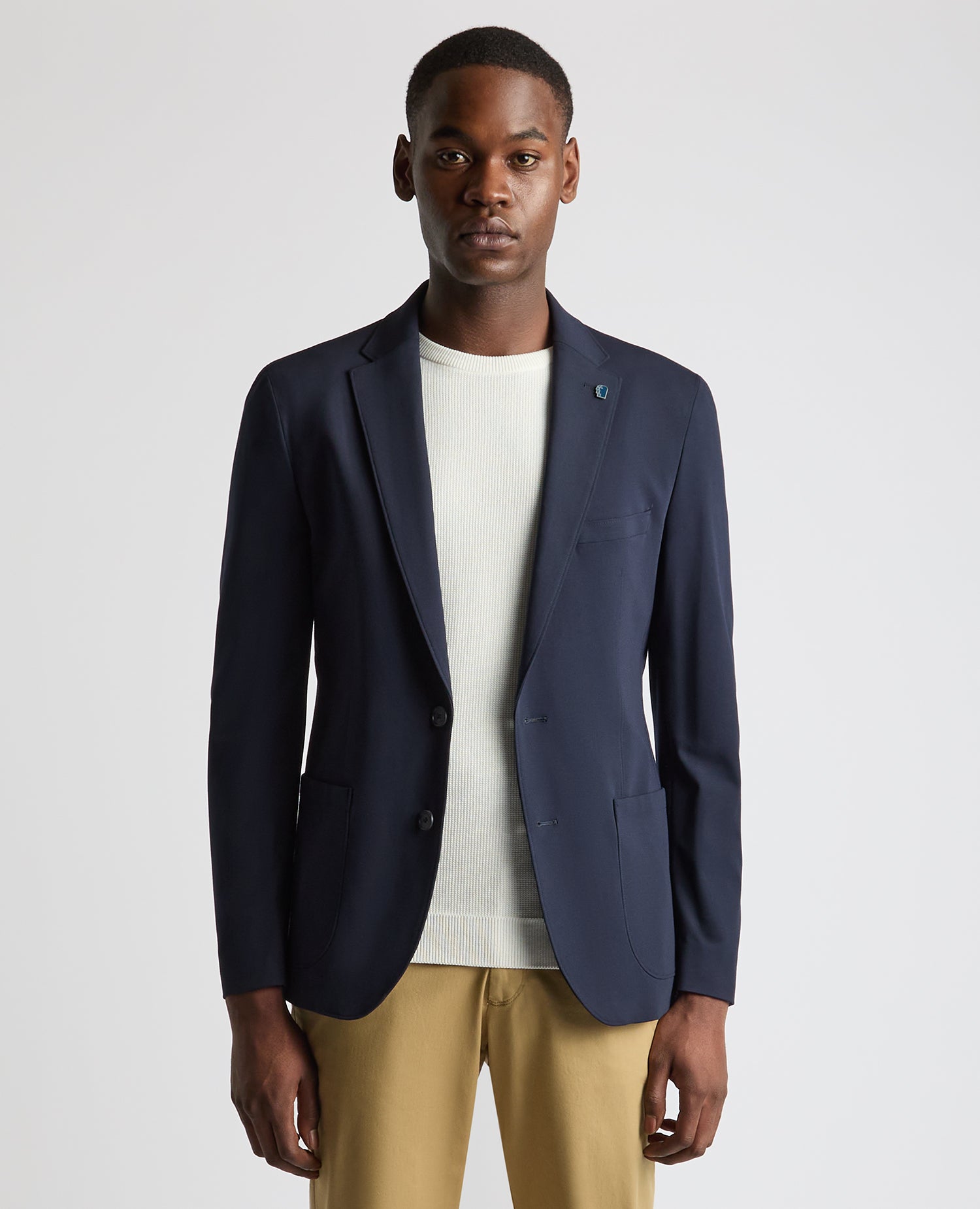 Man wearing a navy Tapered Fit Stretch Jacket
